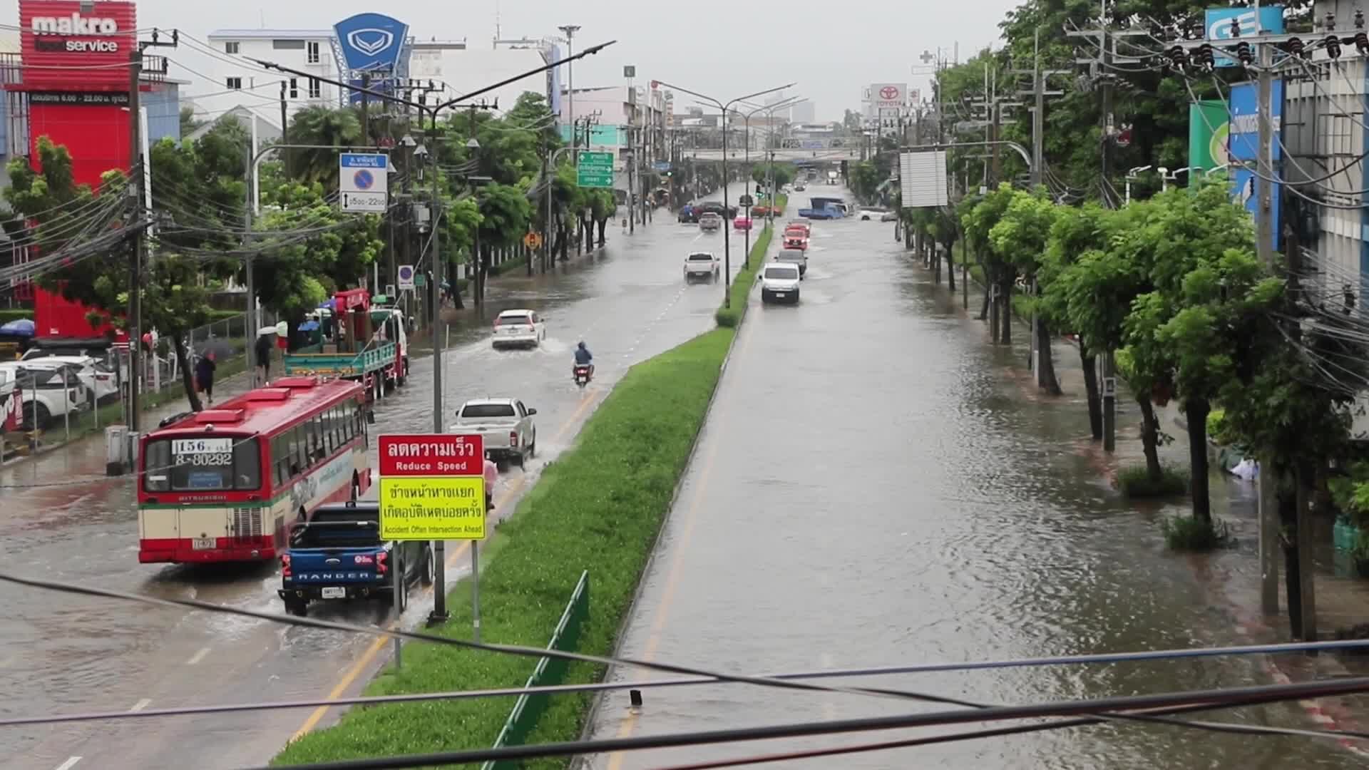 Residents  and motorists battle in floodwater.