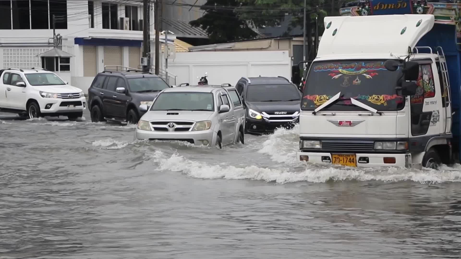 Residents  and motorists battle in floodwater.