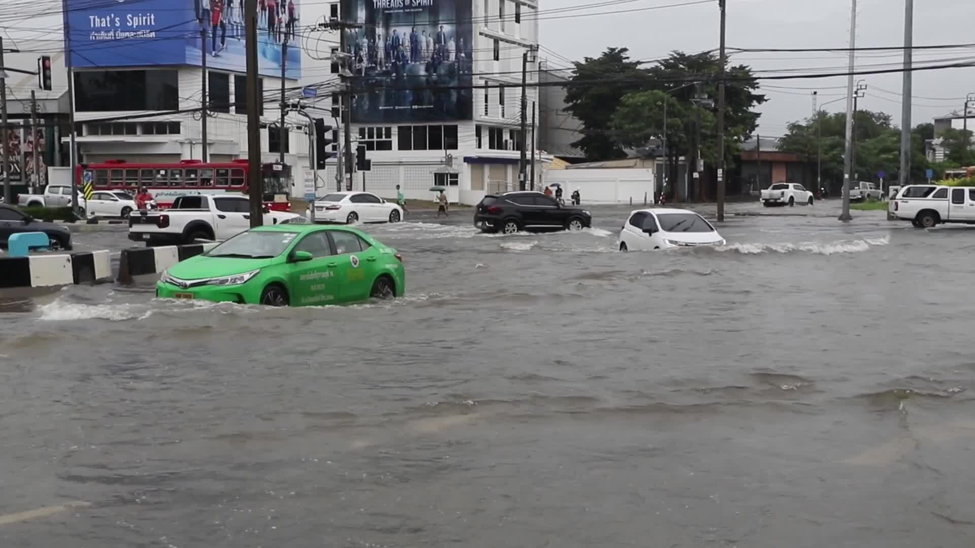 Residents  and motorists battle in floodwater.