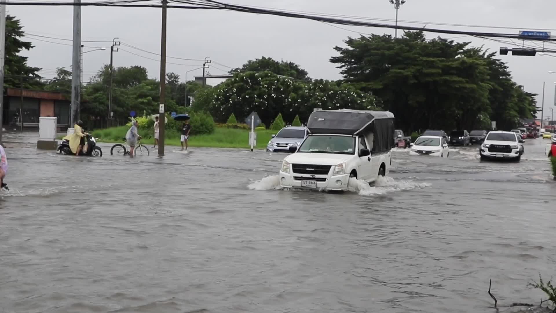Residents  and motorists battle in floodwater.