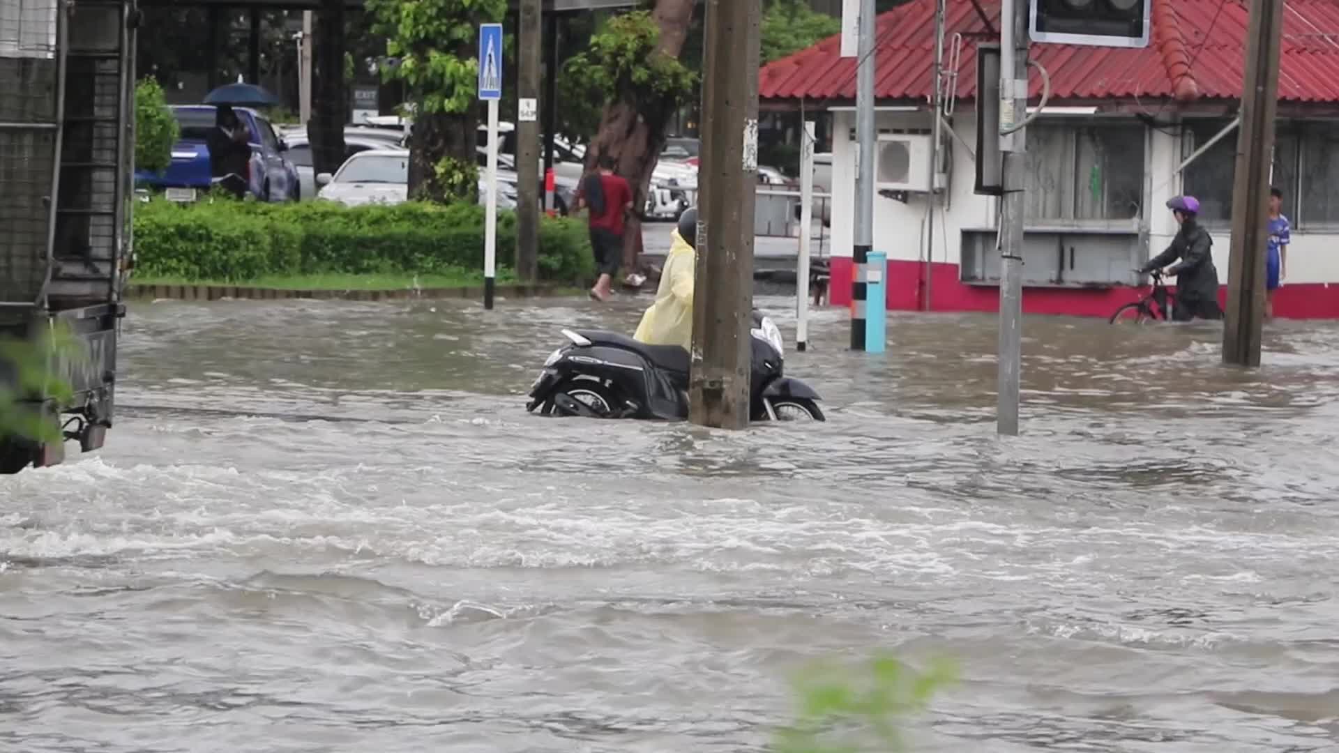 Residents  and motorists battle in floodwater