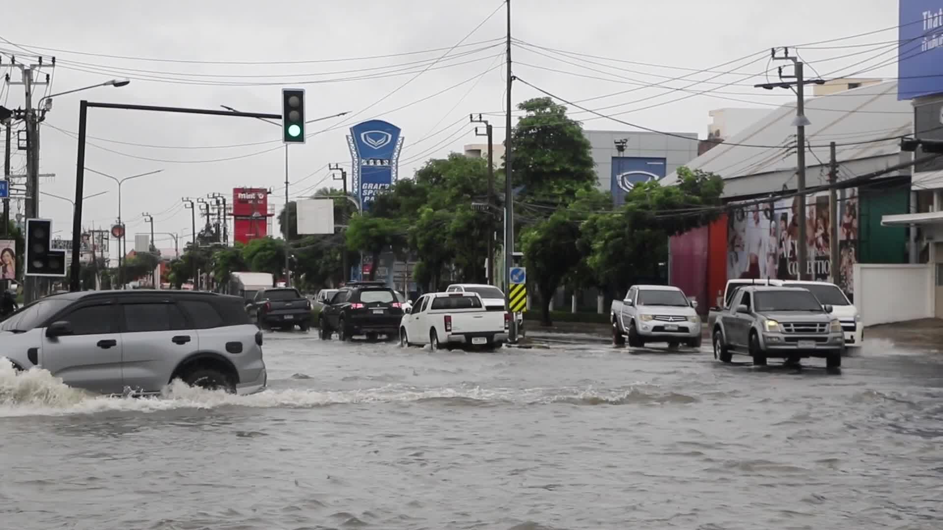 Residents  and motorists battle in floodwater.