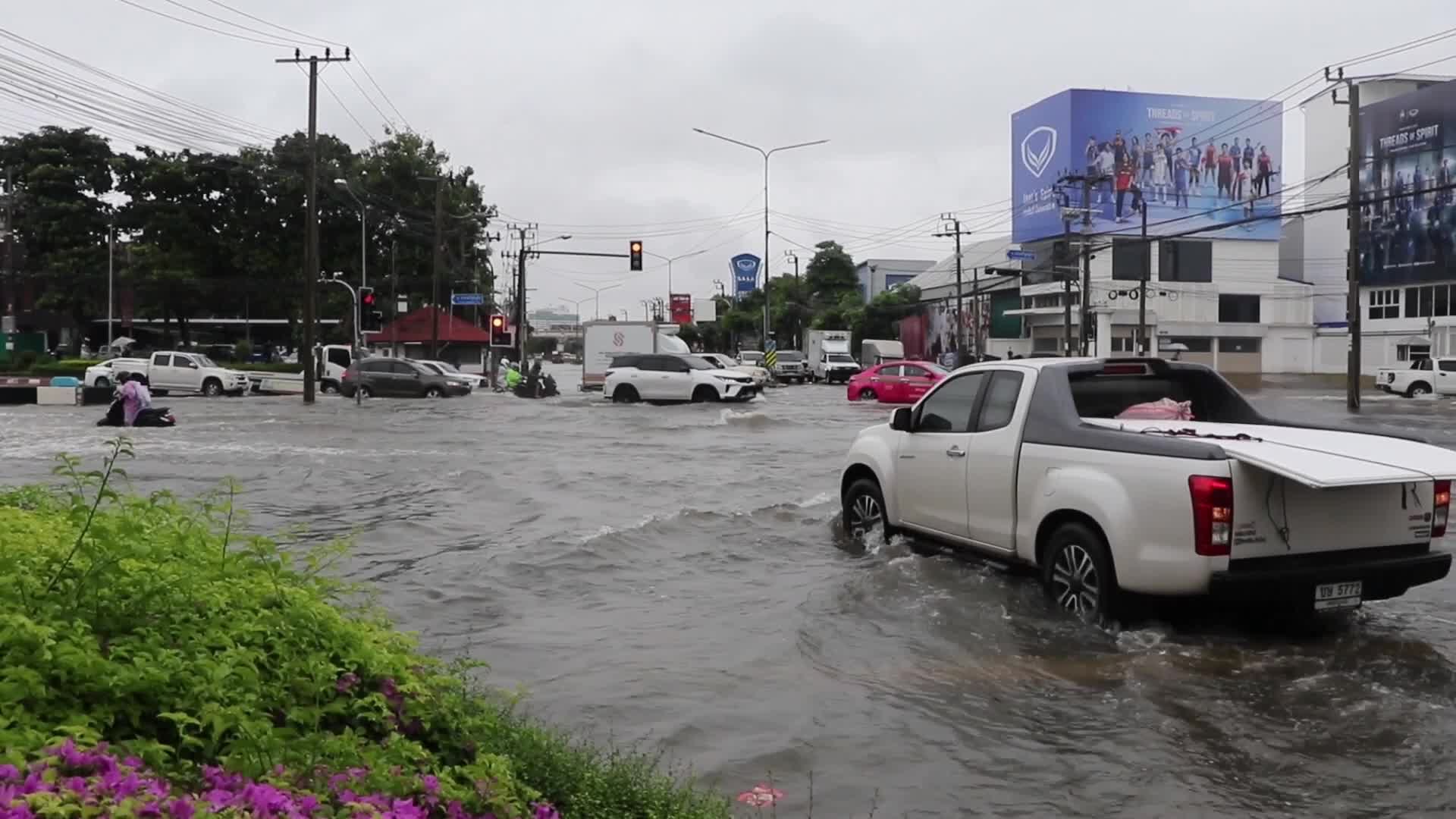 Residents  and motorists battle in floodwater.