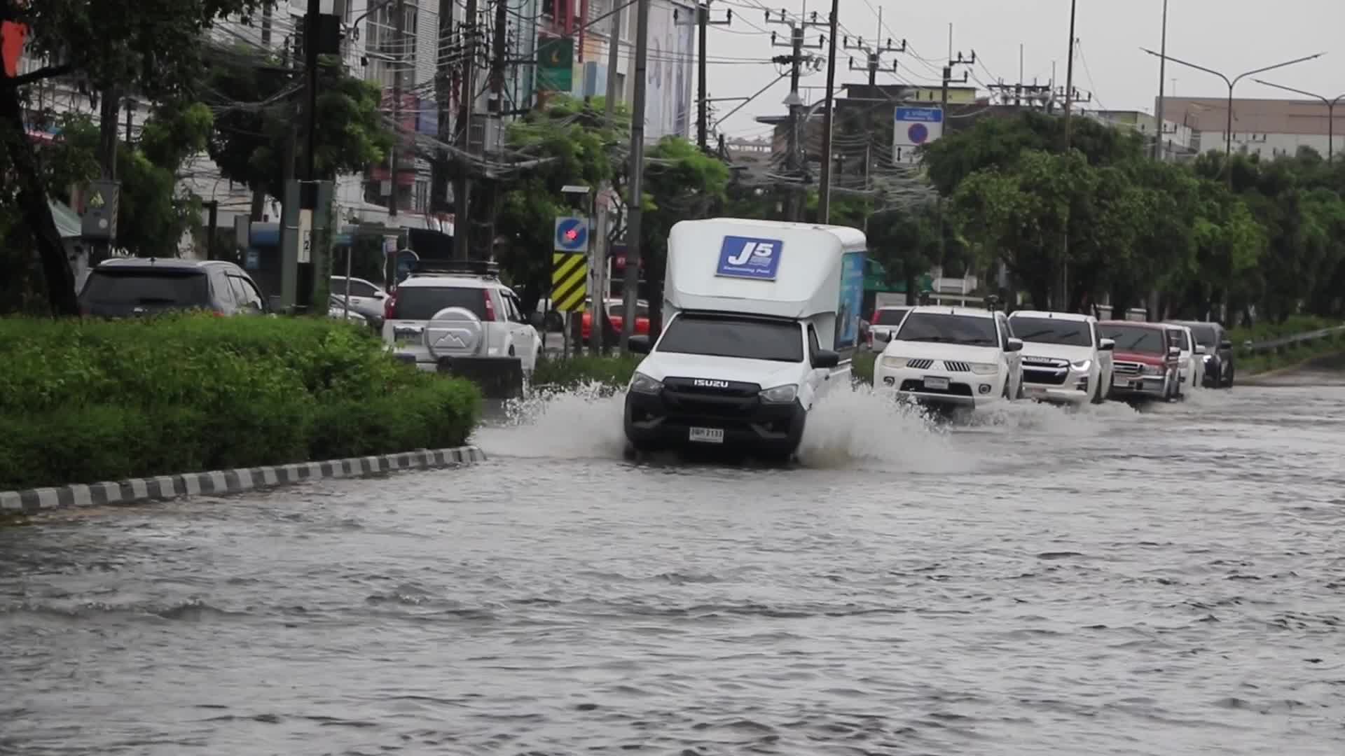 Residents  and motorists battle in floodwater.