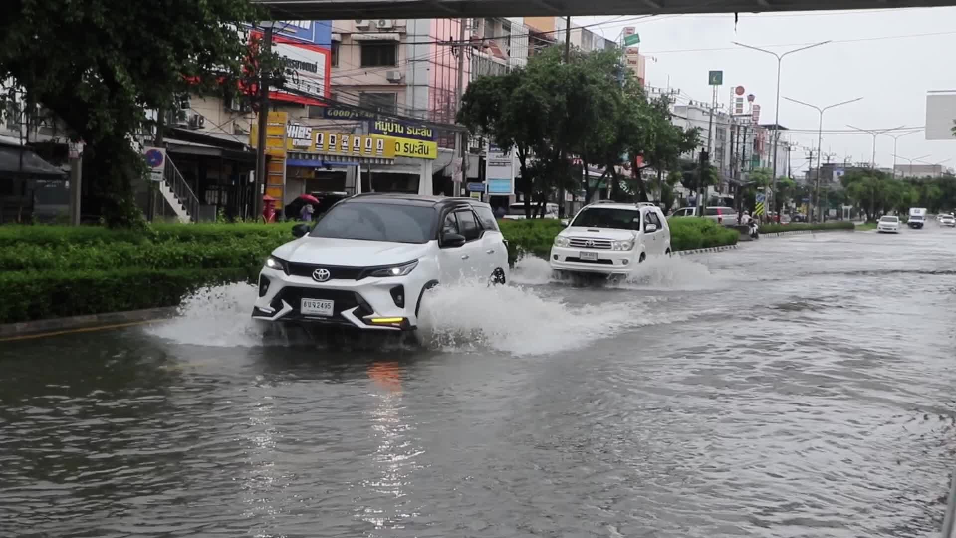 Residents  and motorists battle in floodwater.