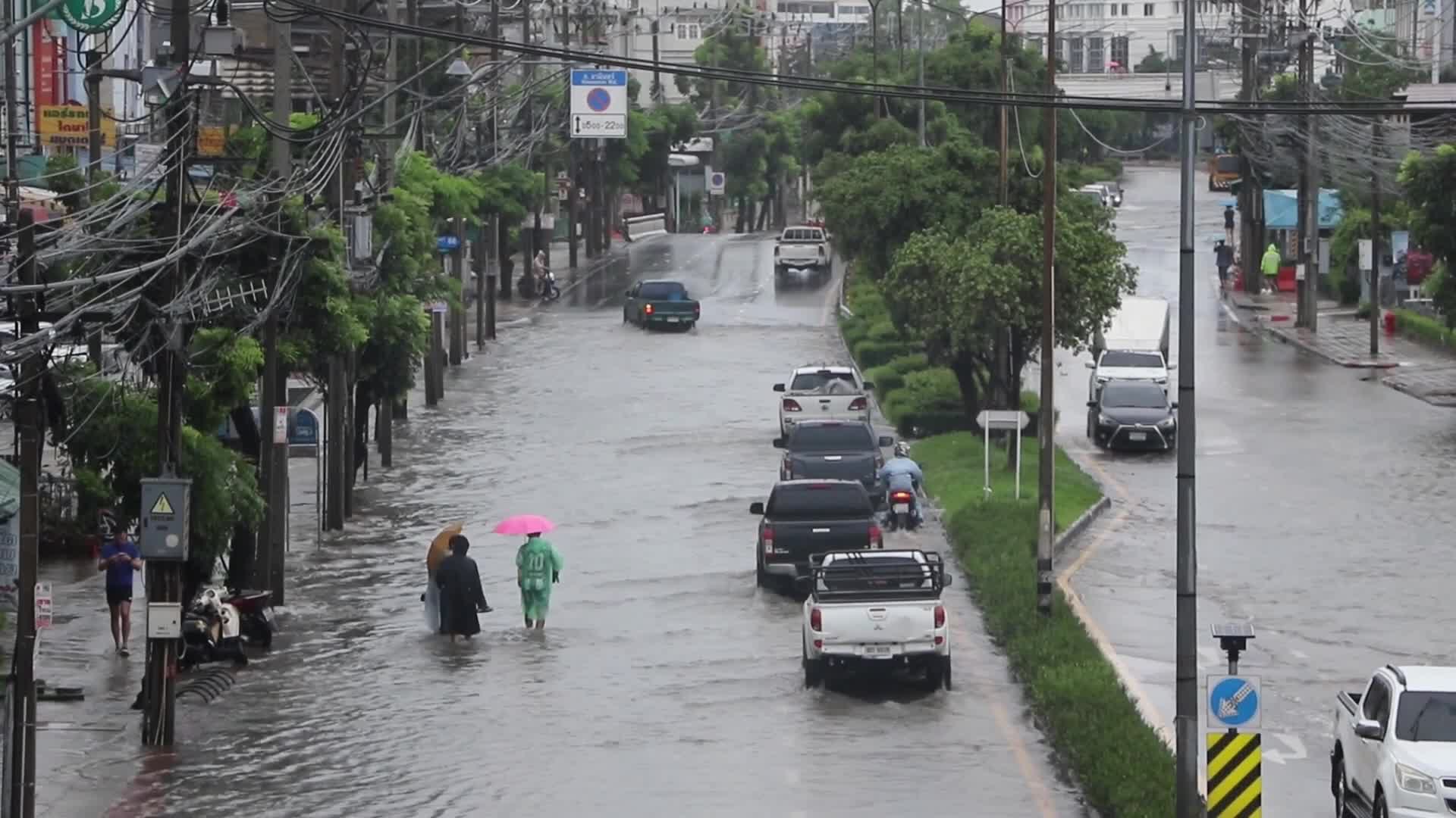 Residents  and motorists battle in floodwater.