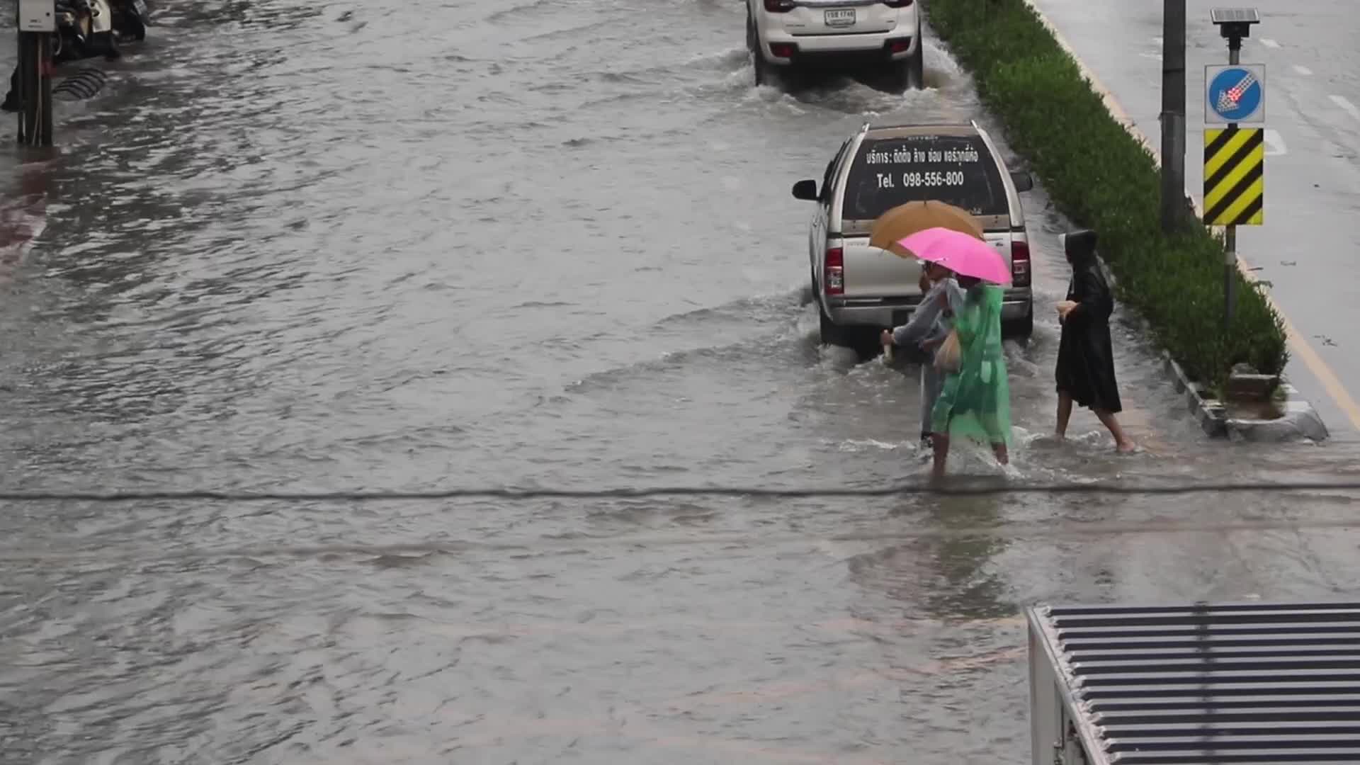 Residents  and motorists battle in floodwater.