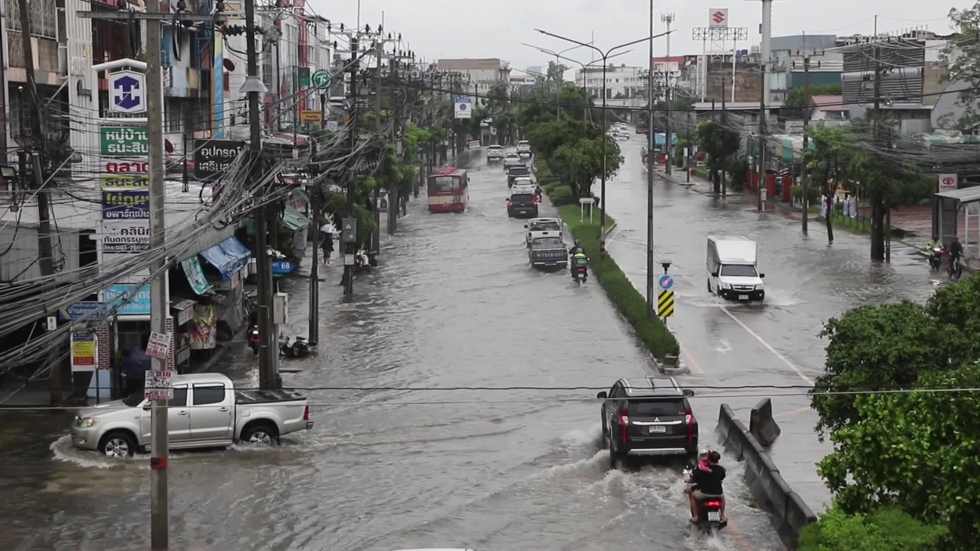 Residents  and motorists battle in floodwater.