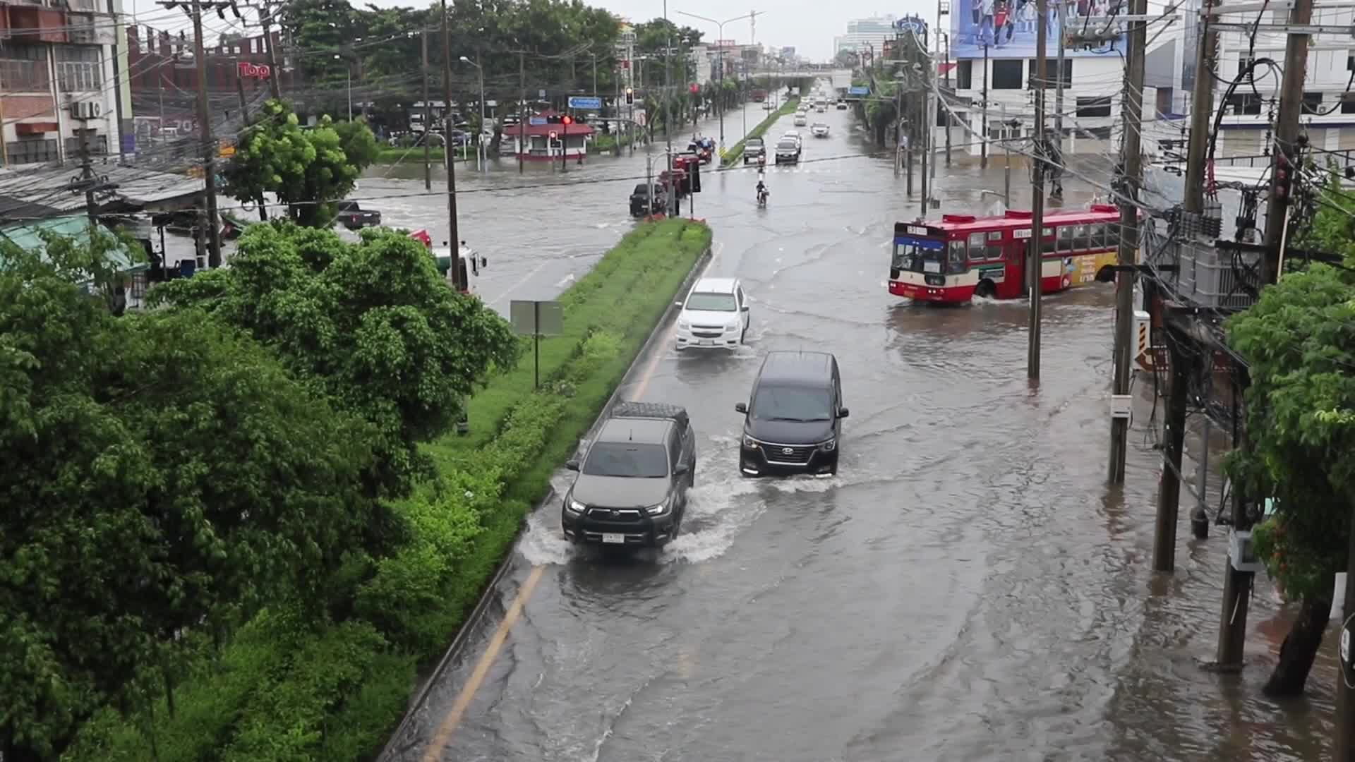 Residents  and motorists battle in floodwater.
