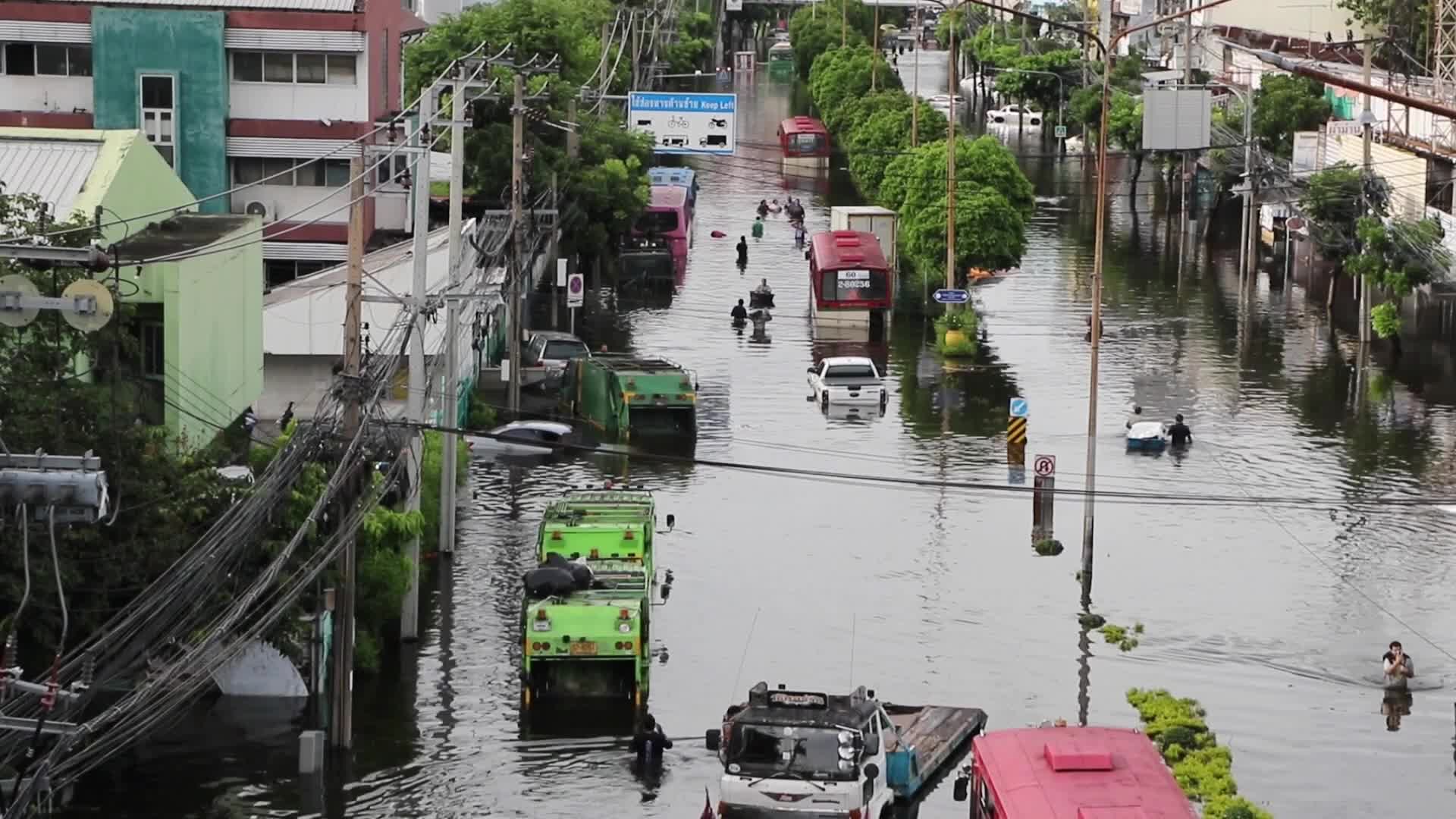 Bangkok residents walk in floodwater