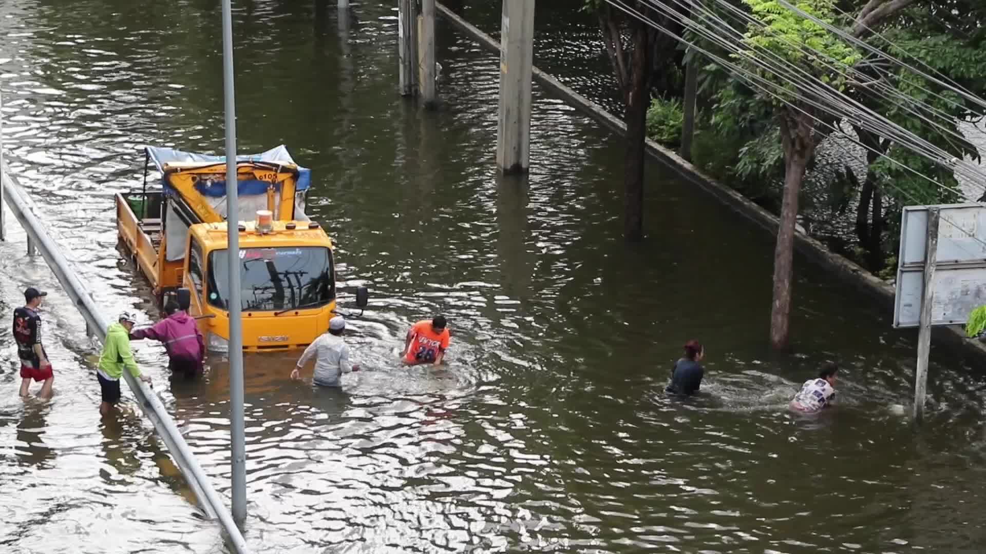 Worker and residents carry sand bags .