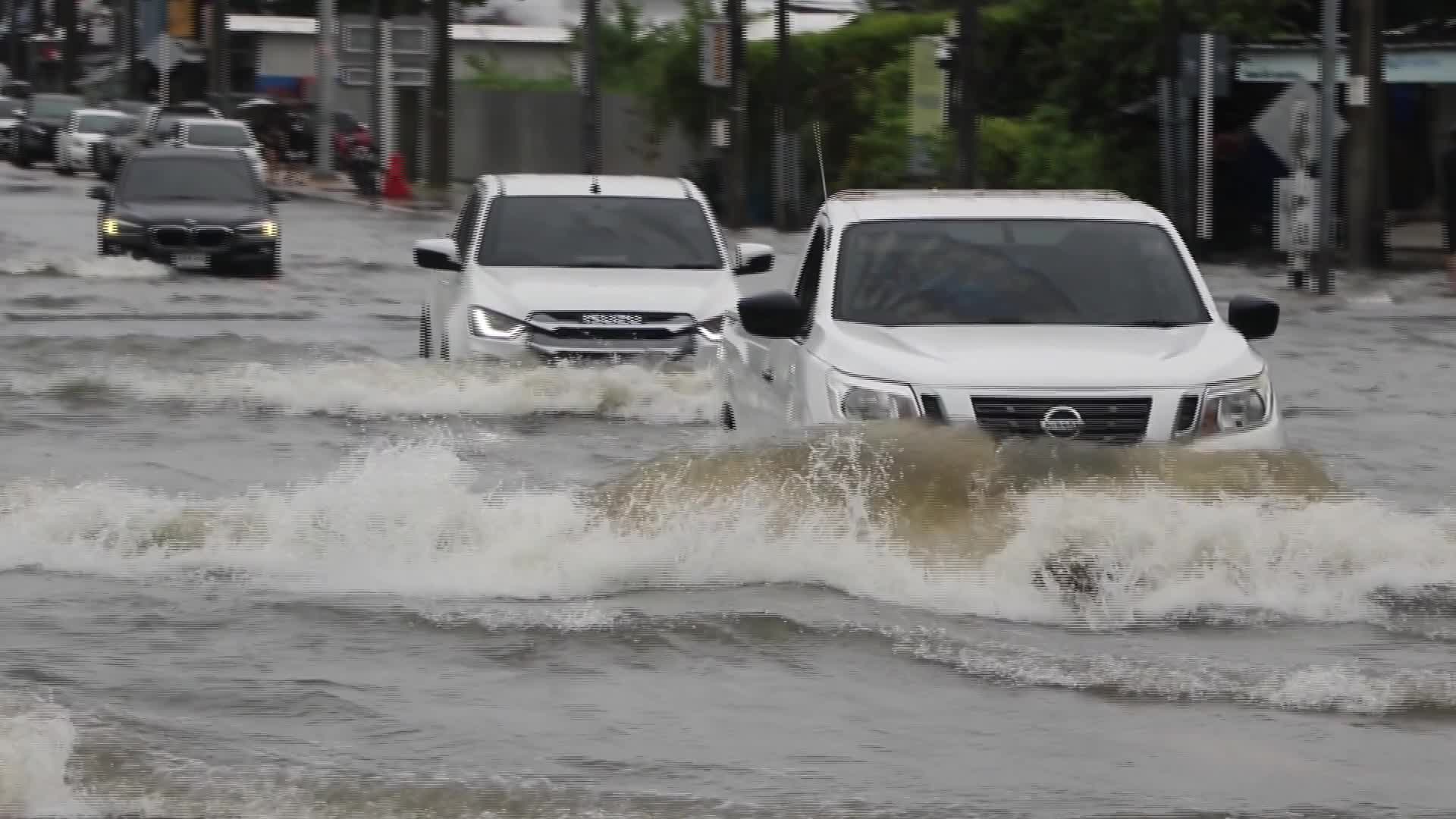 Residents  and motorists battle in floodwater. - 09/26/2026