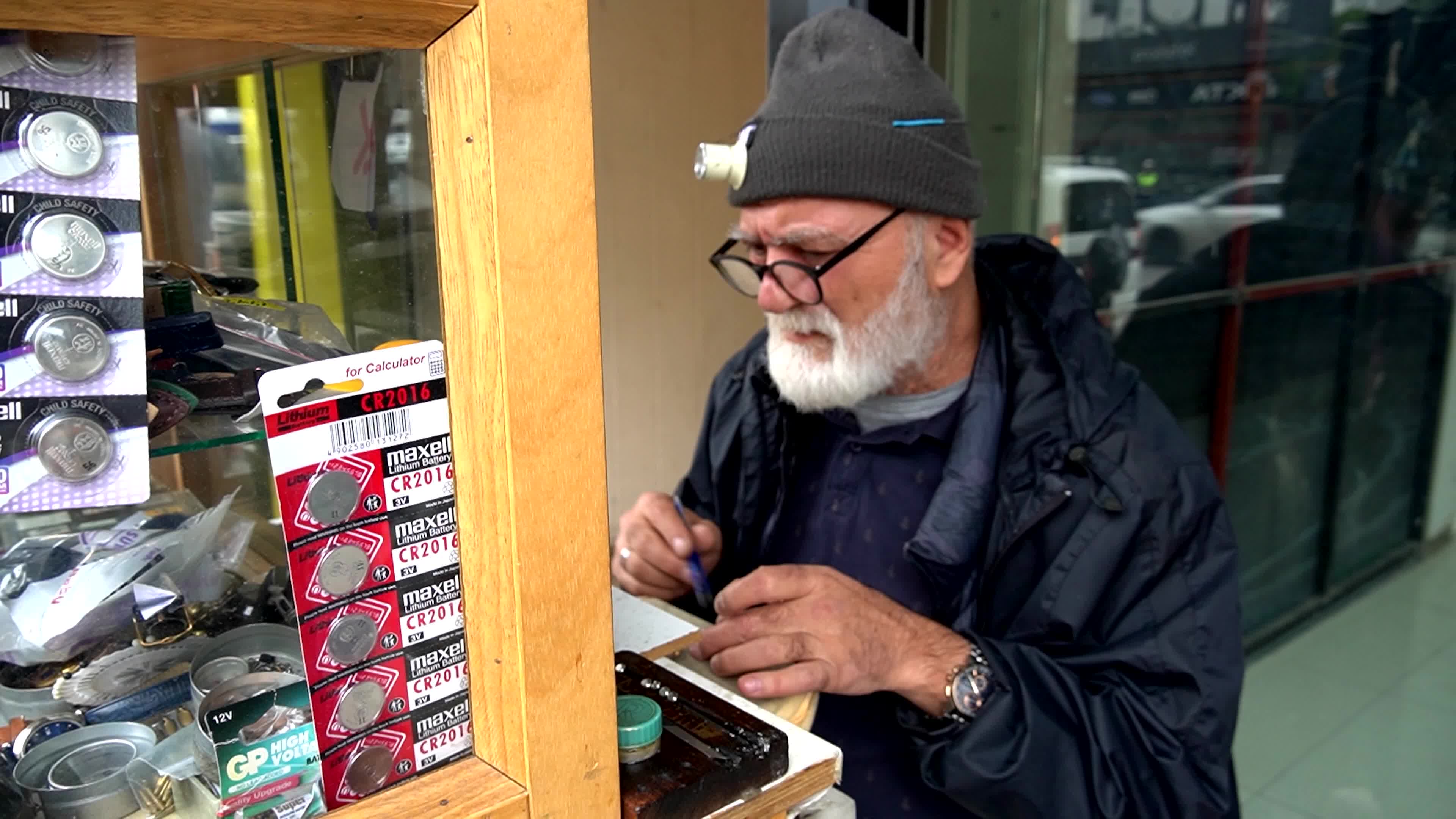 Portrait of a lifelong artisan repairing an old watch