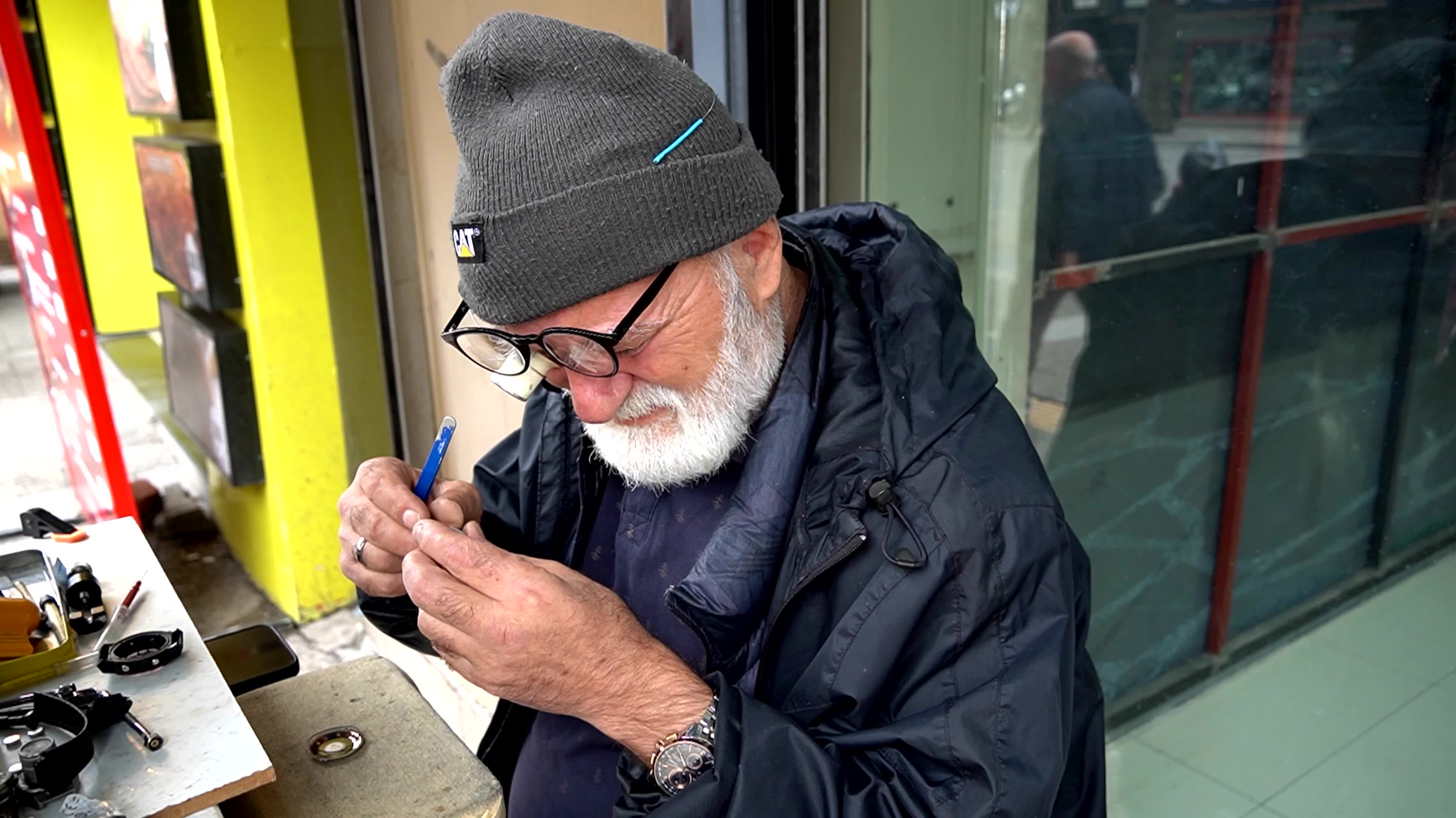 Portrait of a lifelong artisan repairing an old watch