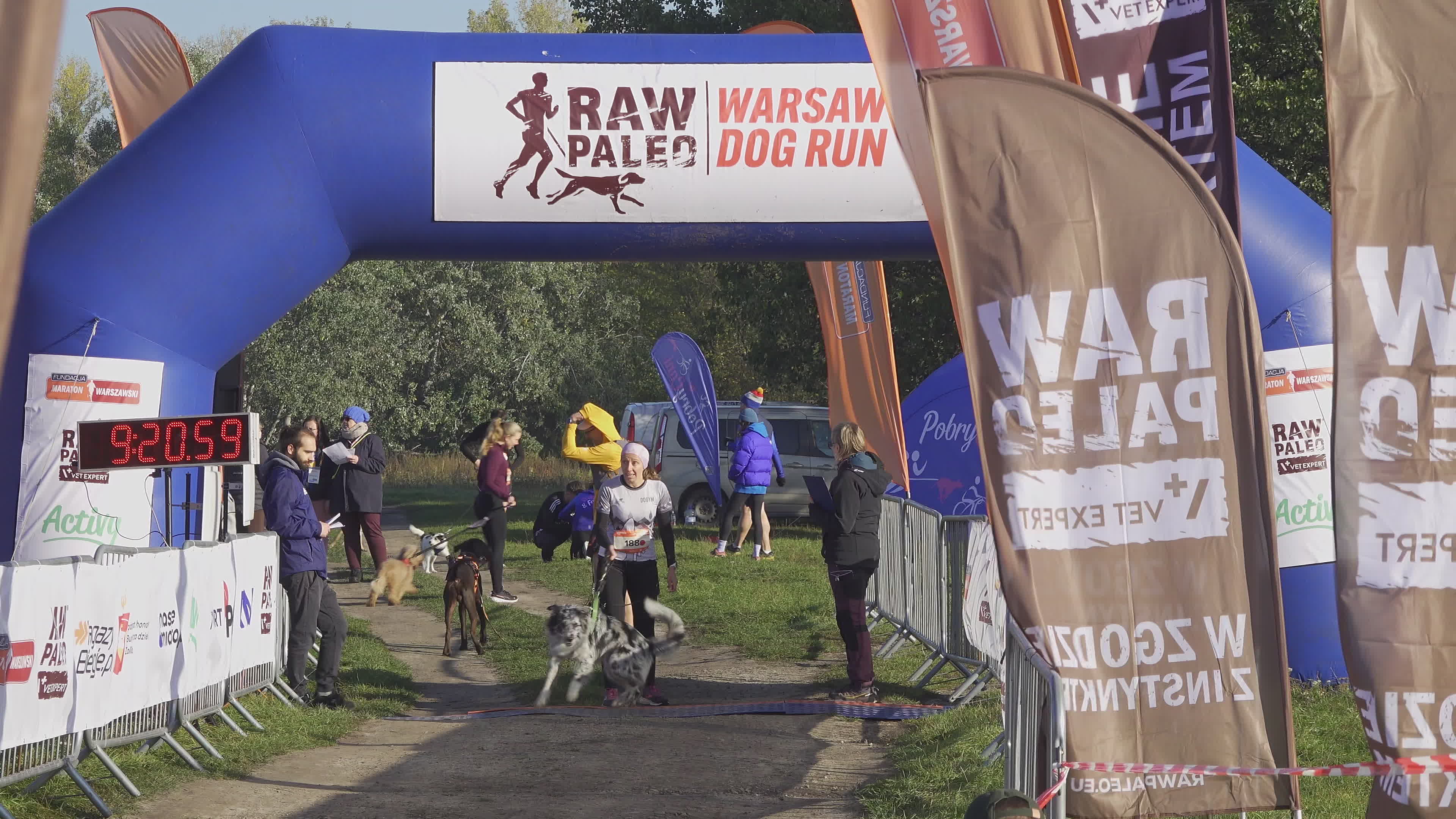 Pet owners run with their dogs in dogtrekking competition in Warsaw