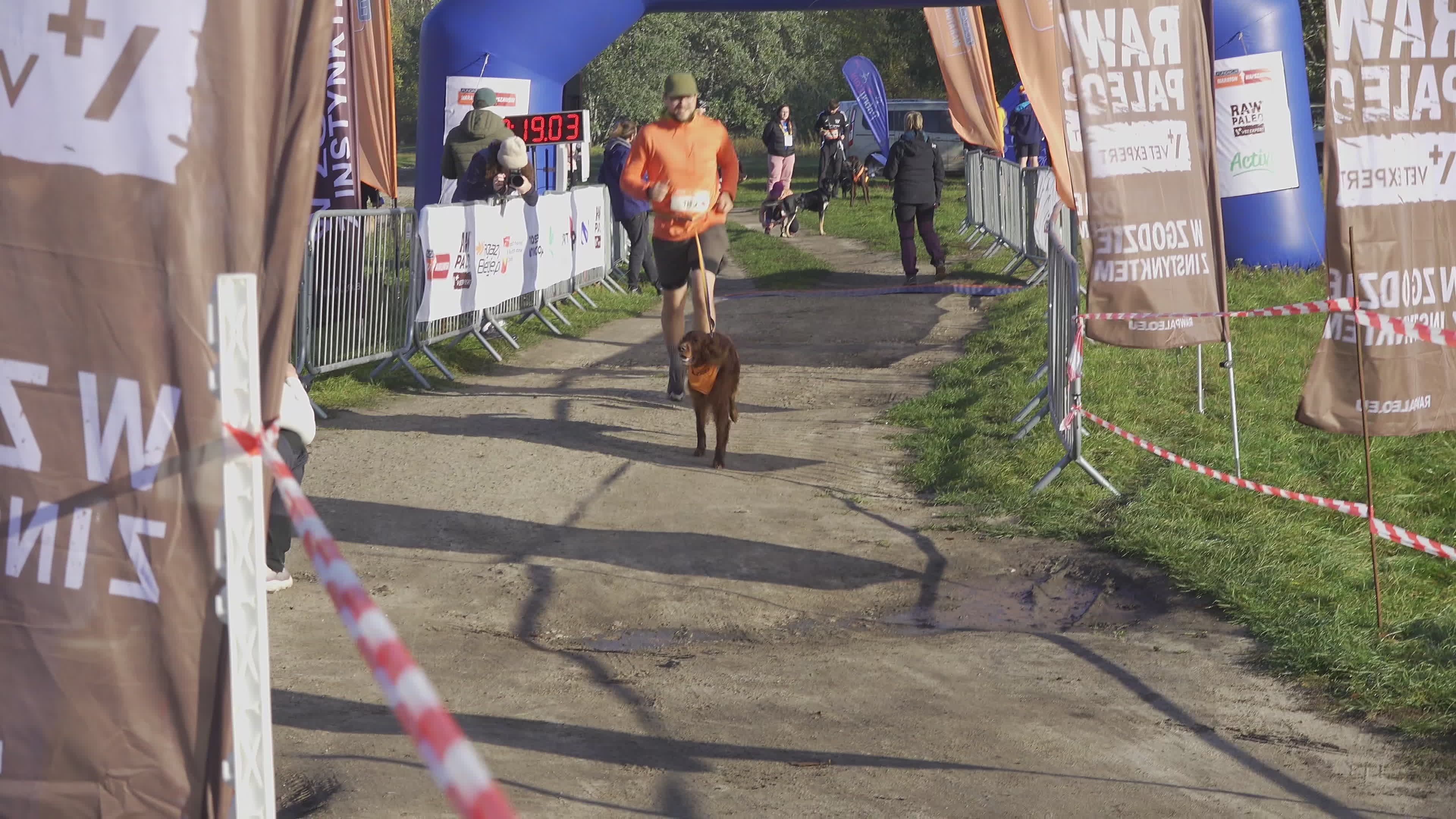 Pet owners run with their dogs in dogtrekking competition in Warsaw