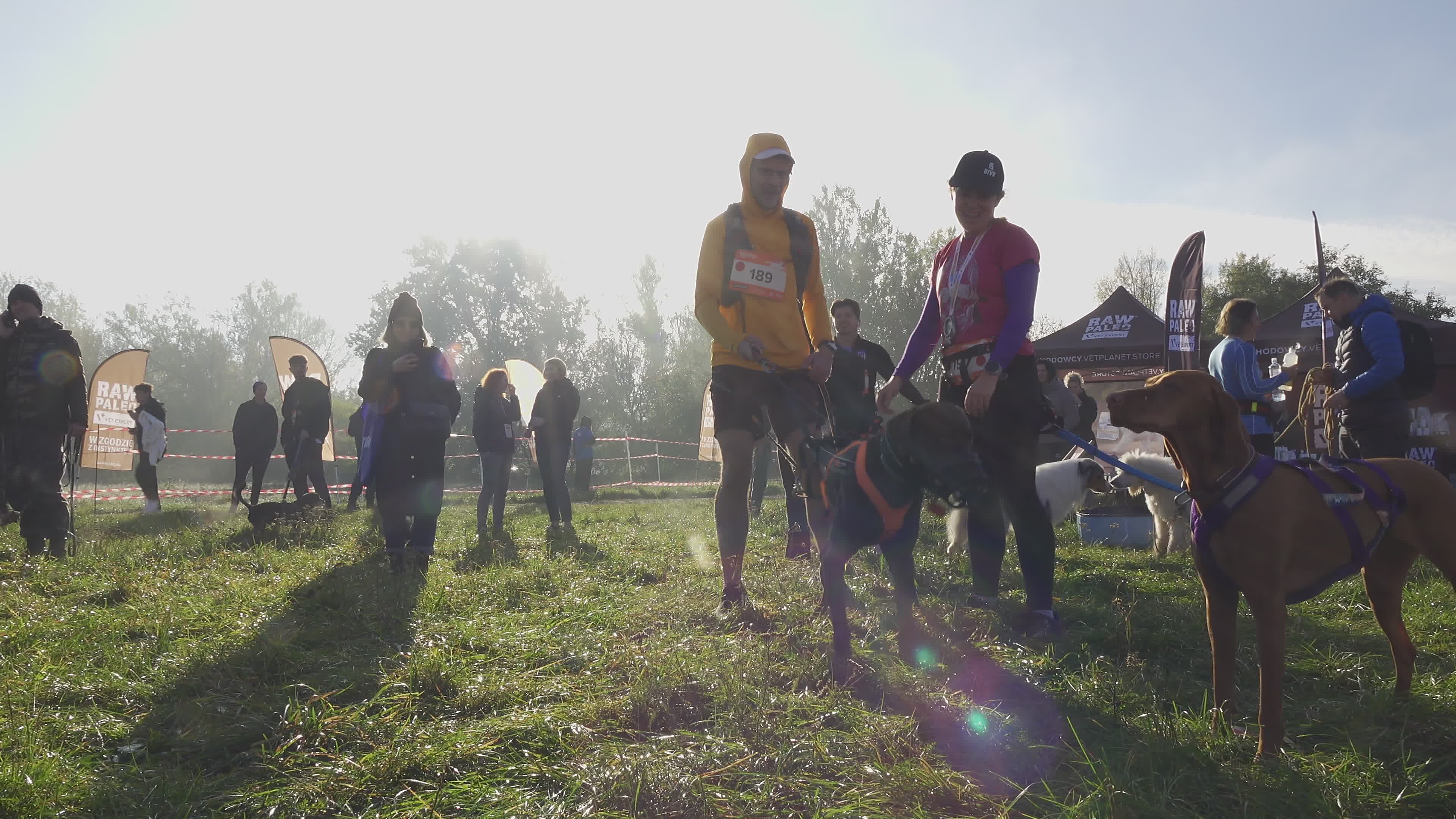 Pet owners run with their dogs in dogtrekking competition in Warsaw