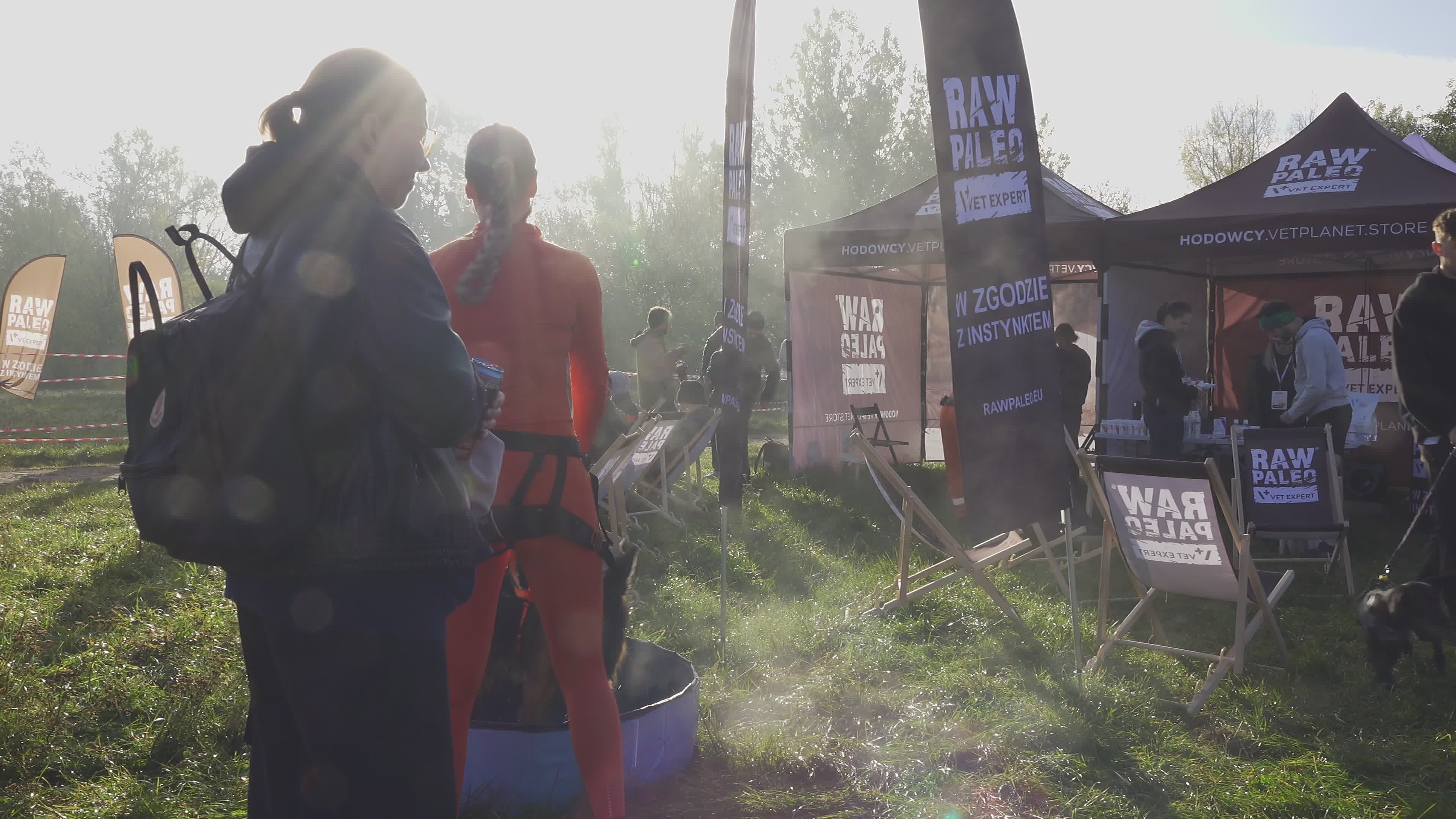 Pet owners run with their dogs in dogtrekking competition in Warsaw