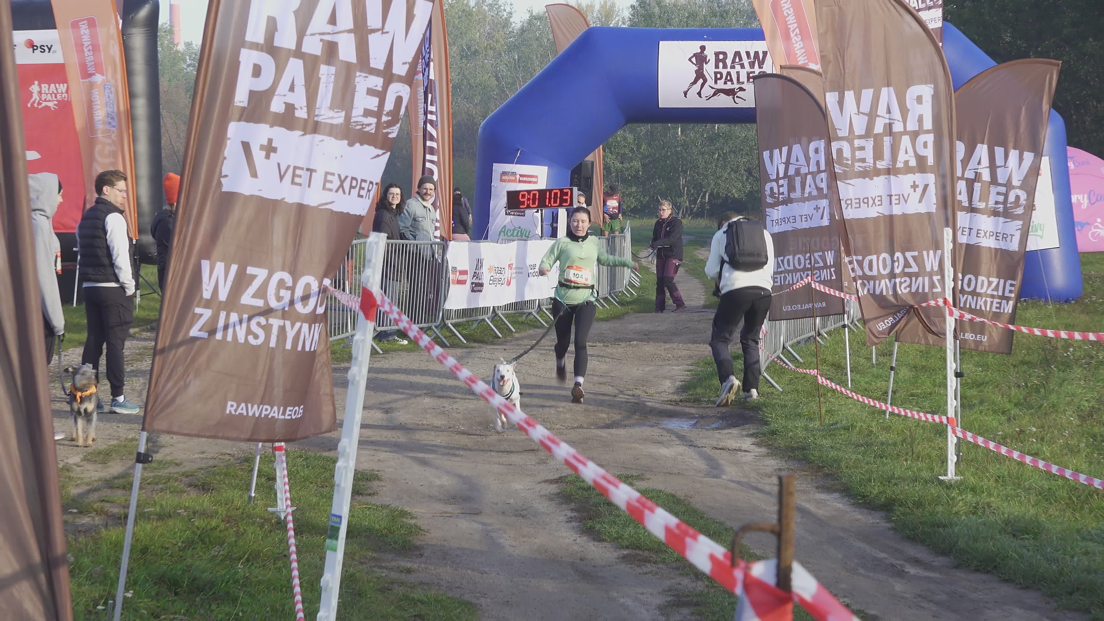 Pet owners run with their dogs in dogtrekking competition in Warsaw