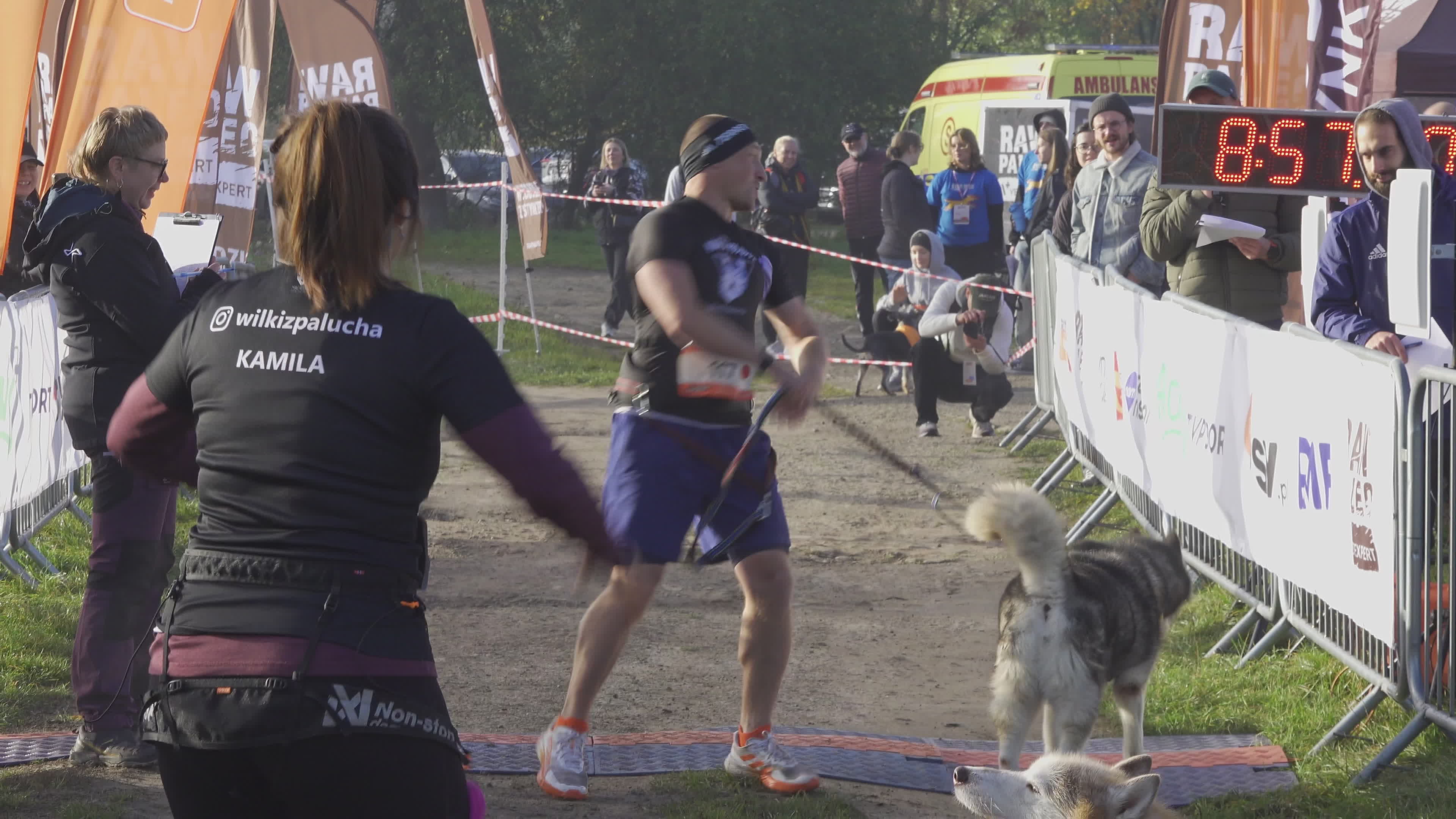 Pet owners run with their dogs in dogtrekking competition in Warsaw