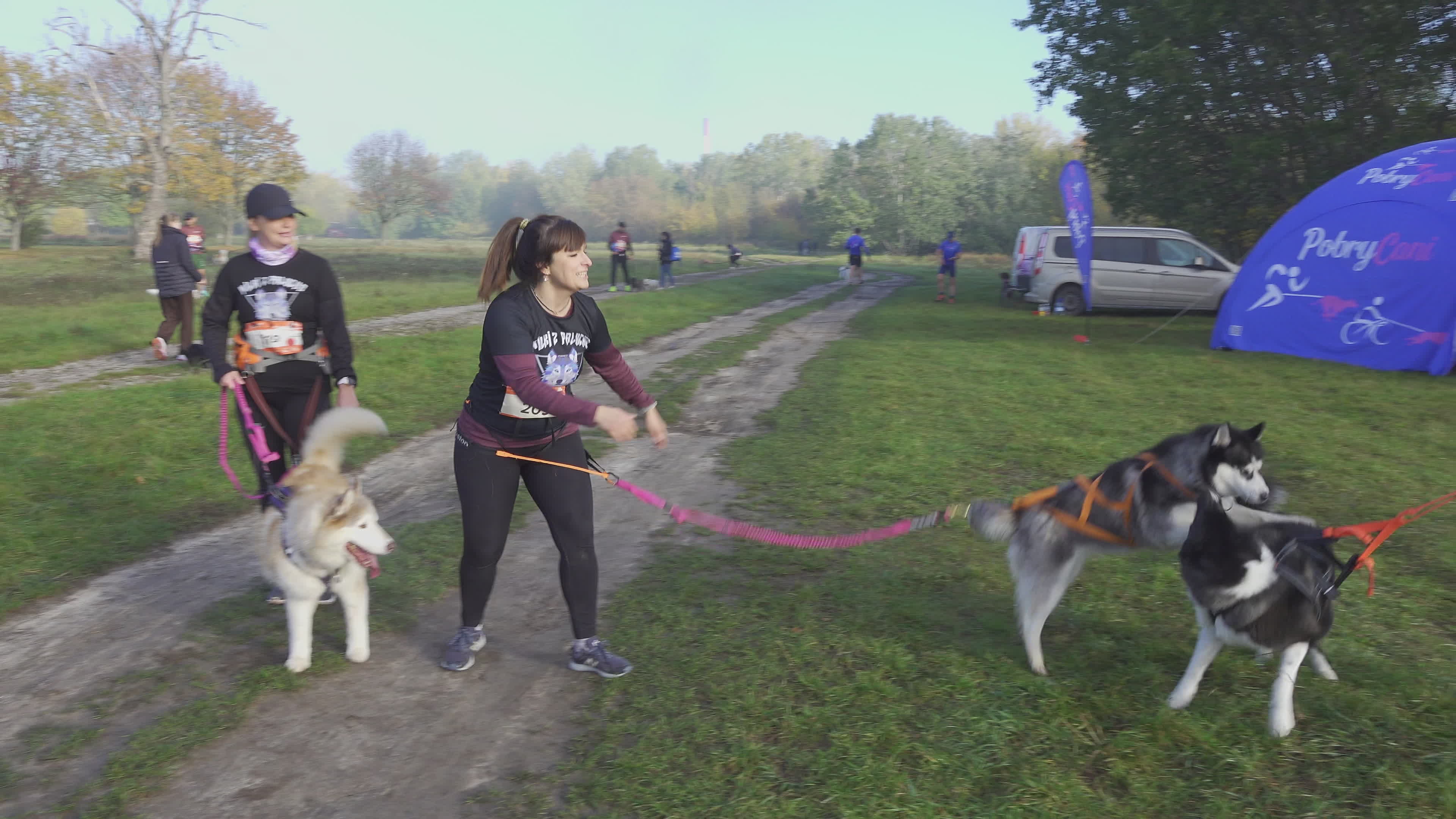 Pet owners run with their dogs in dogtrekking competition in Warsaw