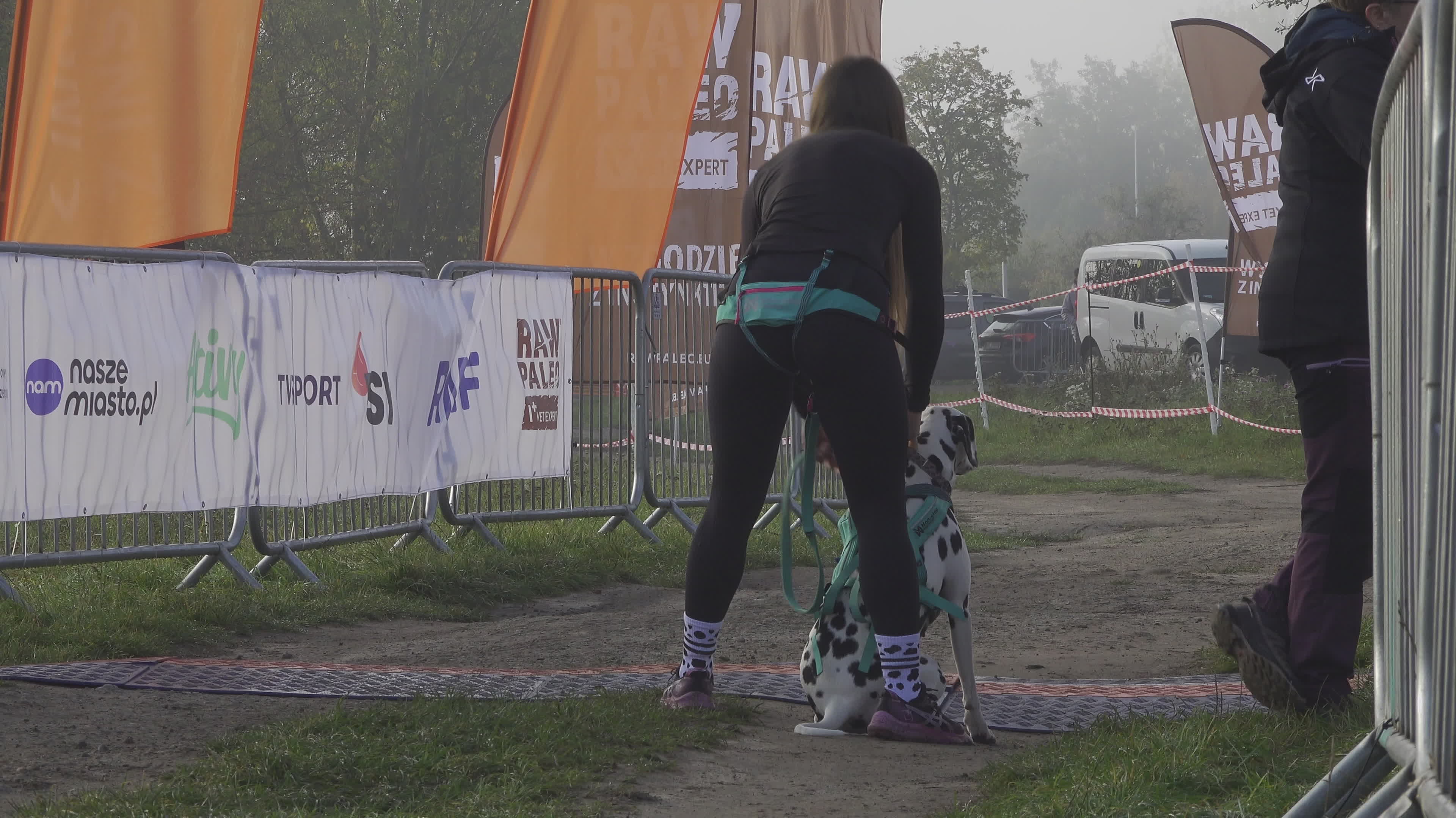 Pet owners run with their dogs in dogtrekking competition in Warsaw