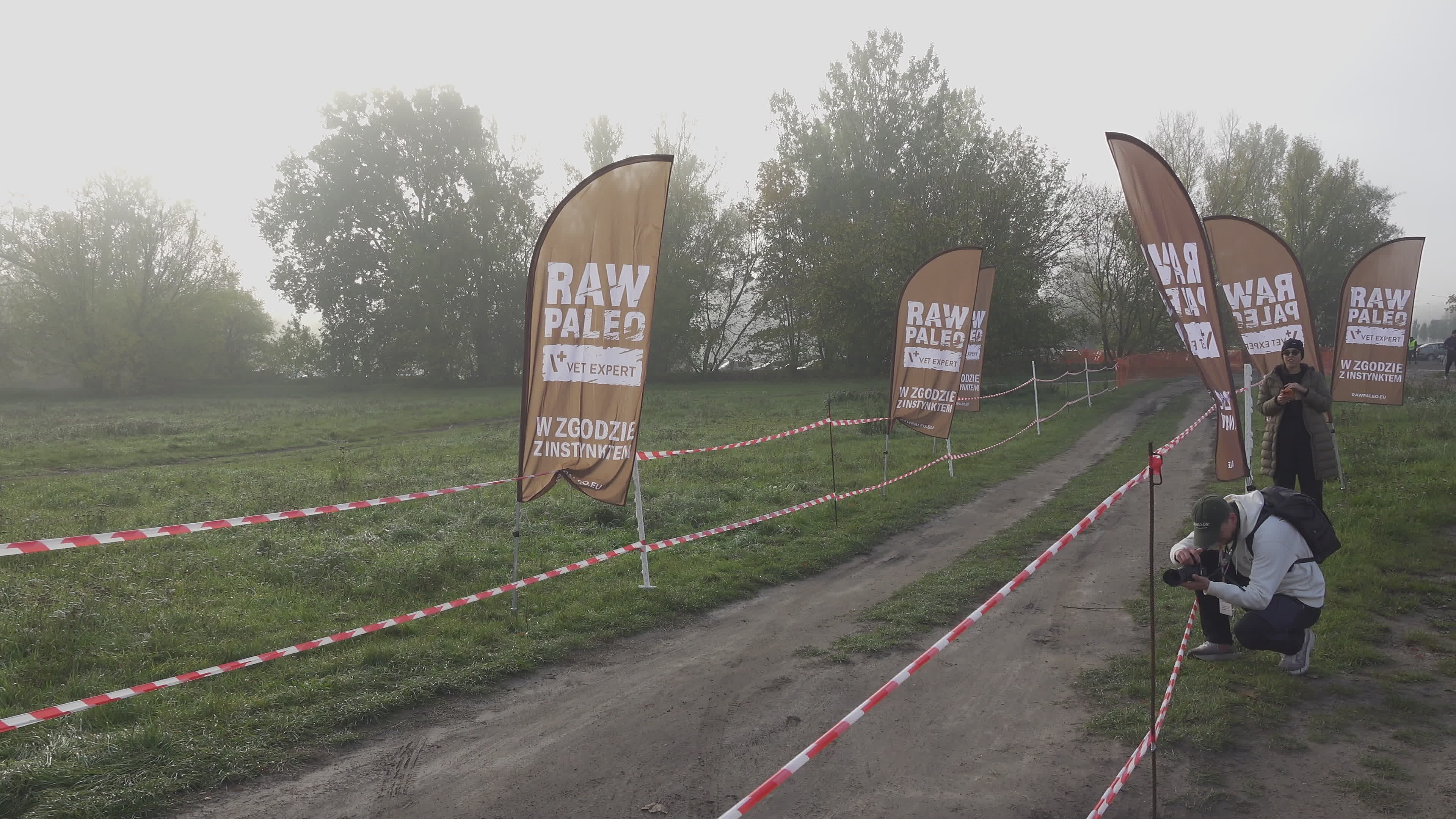 Pet owners run with their dogs in dogtrekking competition in Warsaw