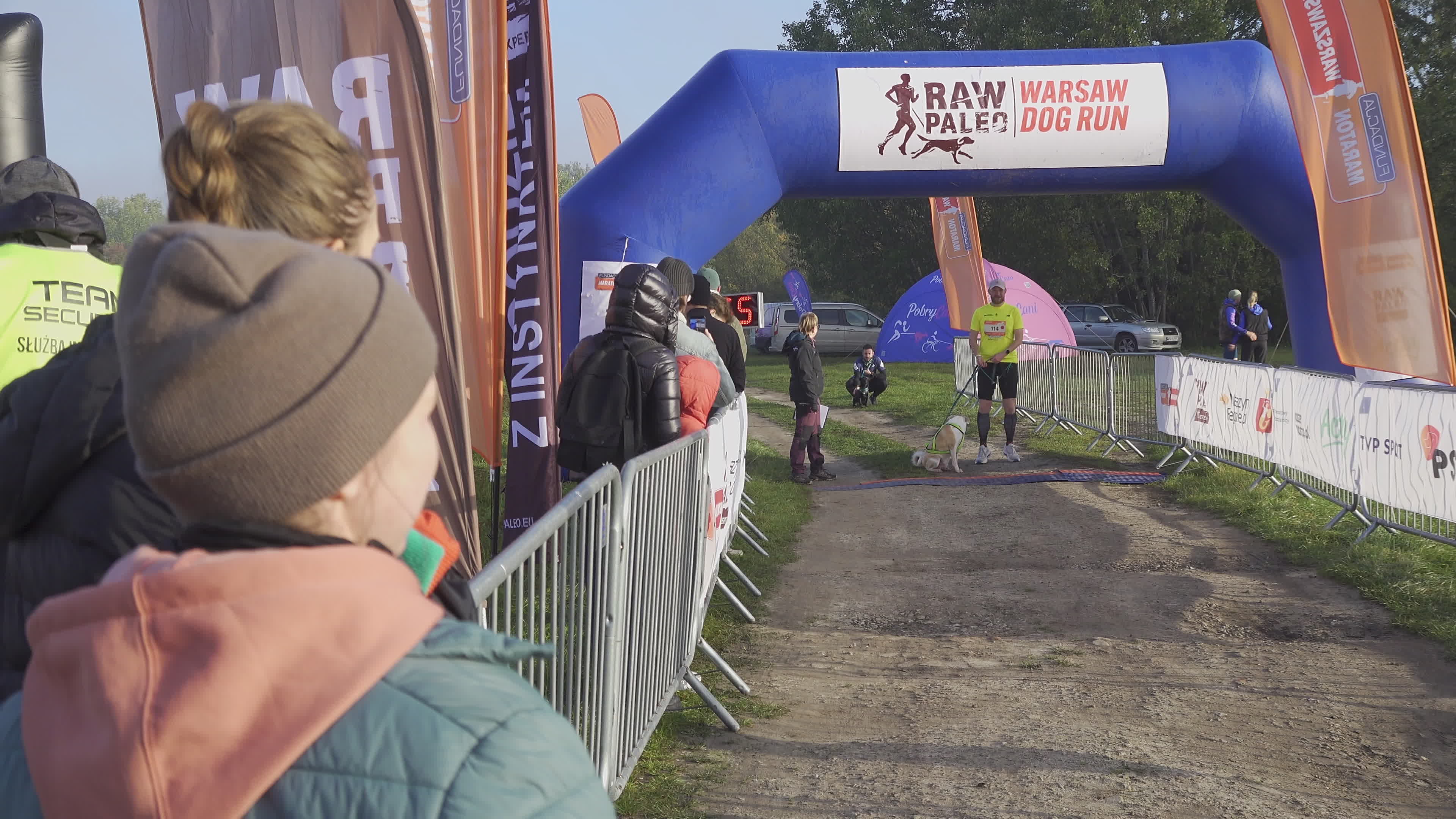 Pet owners run with their dogs in dogtrekking competition in Warsaw