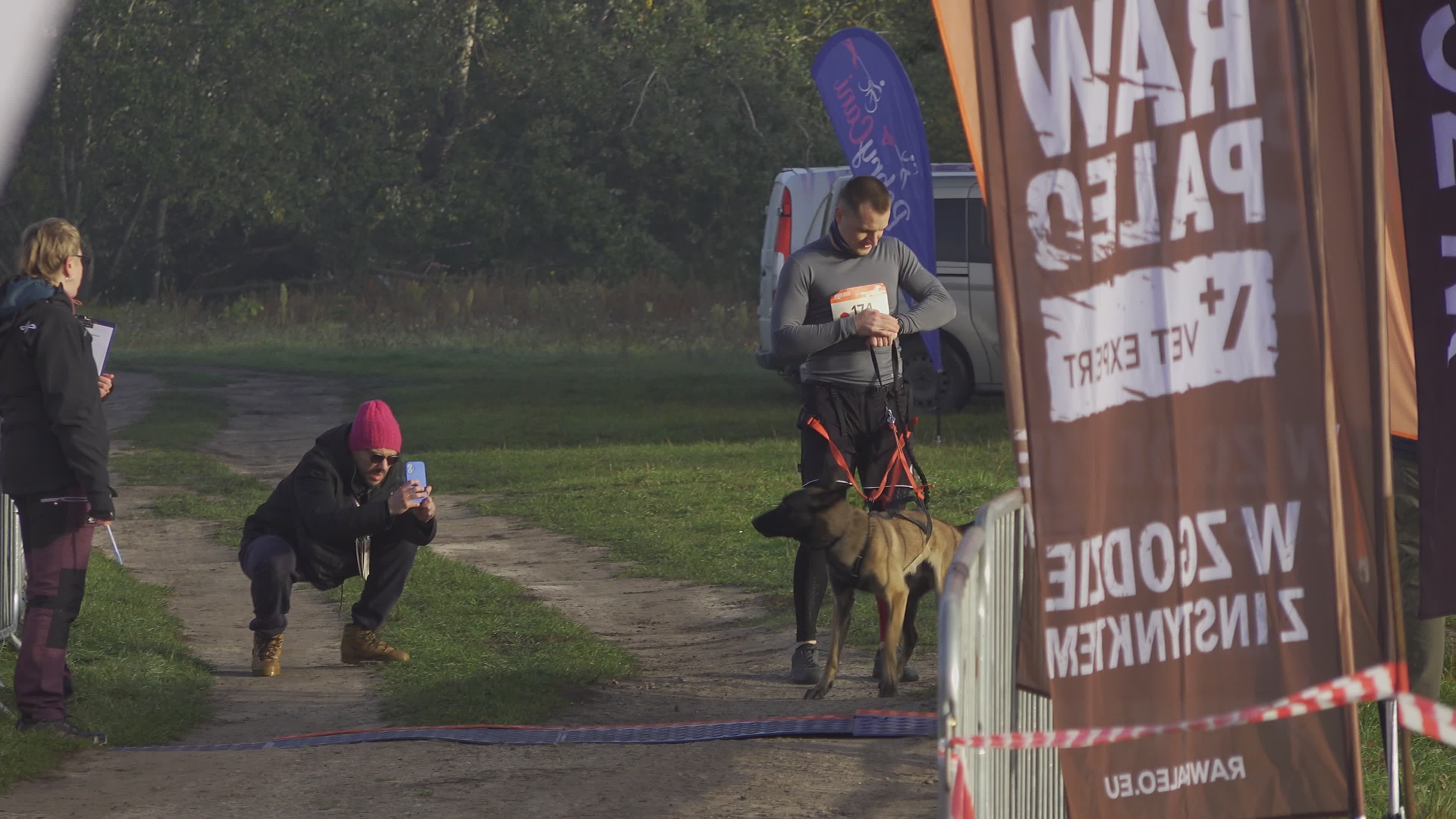 Pet owners run with their dogs in dogtrekking competition in Warsaw
