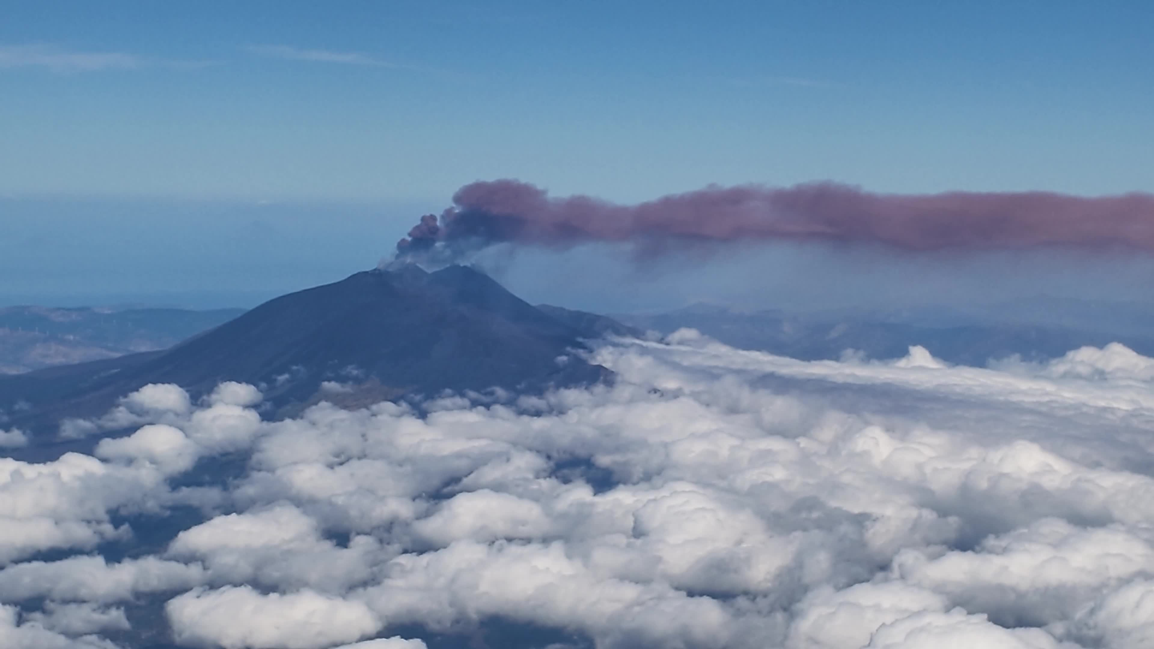 Mount Etna Eruption from Airplane Window: Ash Cloud and Air Traffic Disruption in Sicily