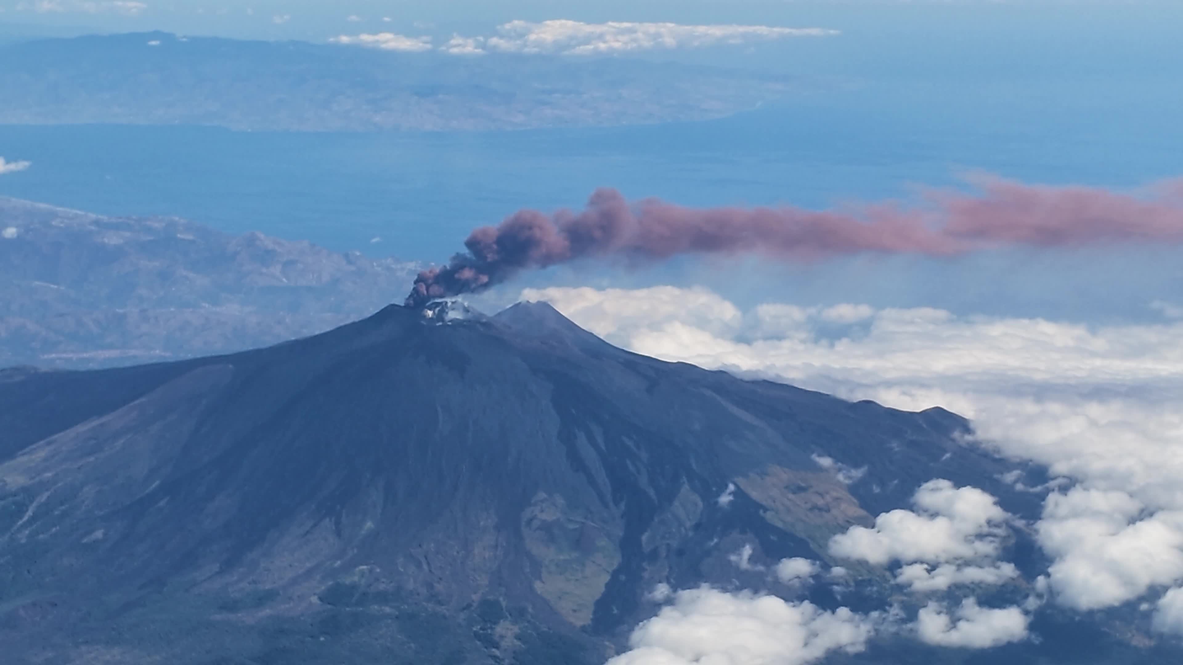 Mount Etna Eruption from Airplane Window: Ash Cloud and Air Traffic Disruption in Sicily