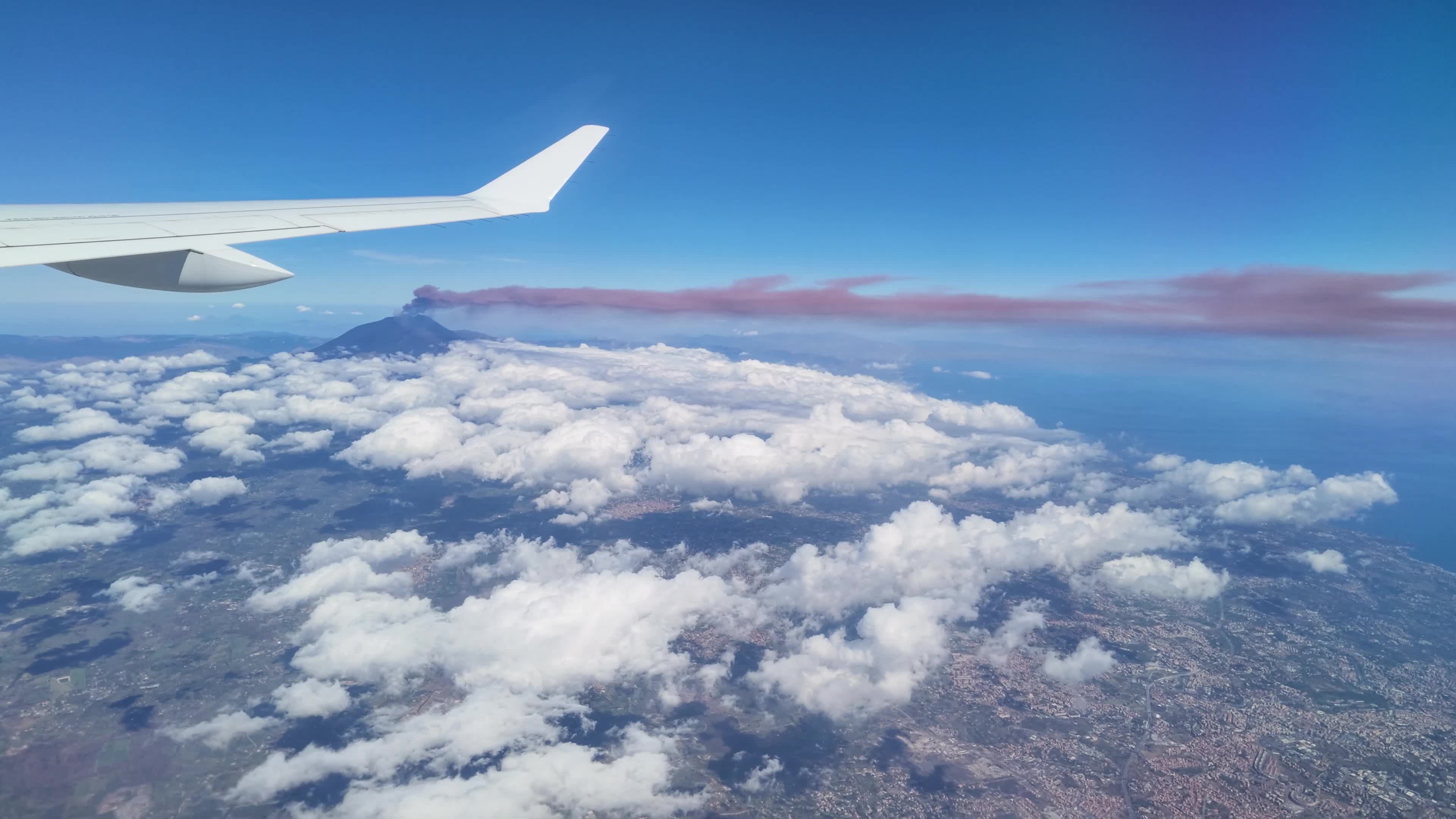 Mount Etna Eruption from Airplane Window: Ash Cloud and Air Traffic Disruption in Sicily