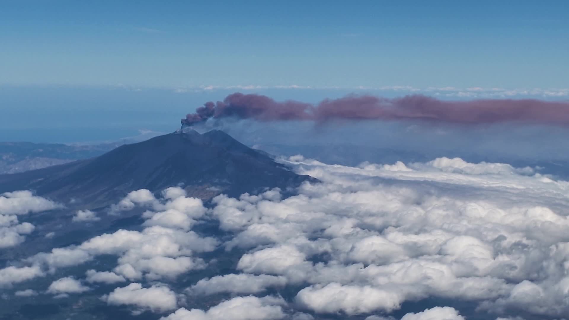 Mount Etna Eruption from Airplane Window: Ash Cloud and Air Traffic Disruption in Sicily