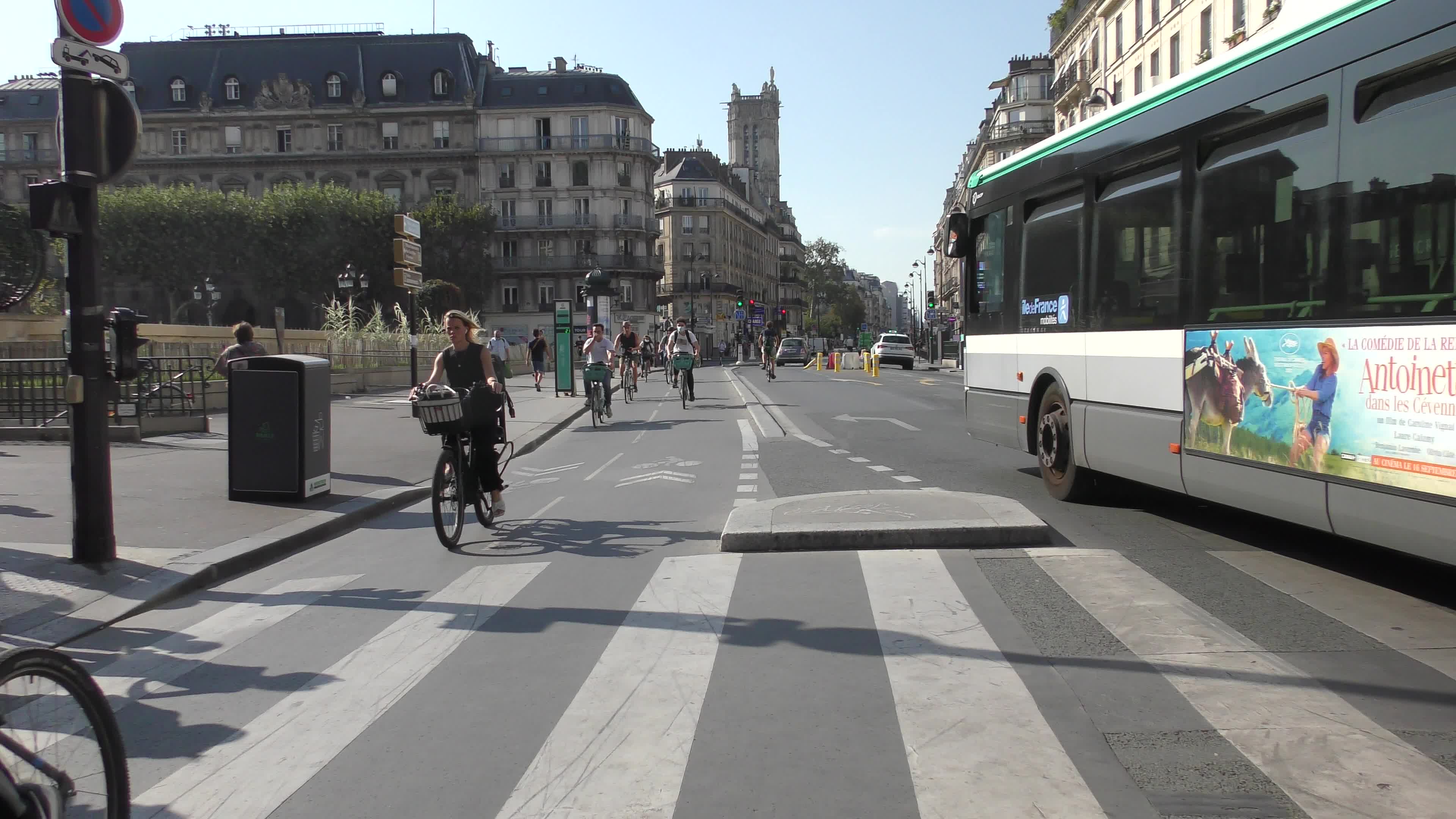 Parisians and commuters cyclists rides in Paris on Rue de Rivoli 