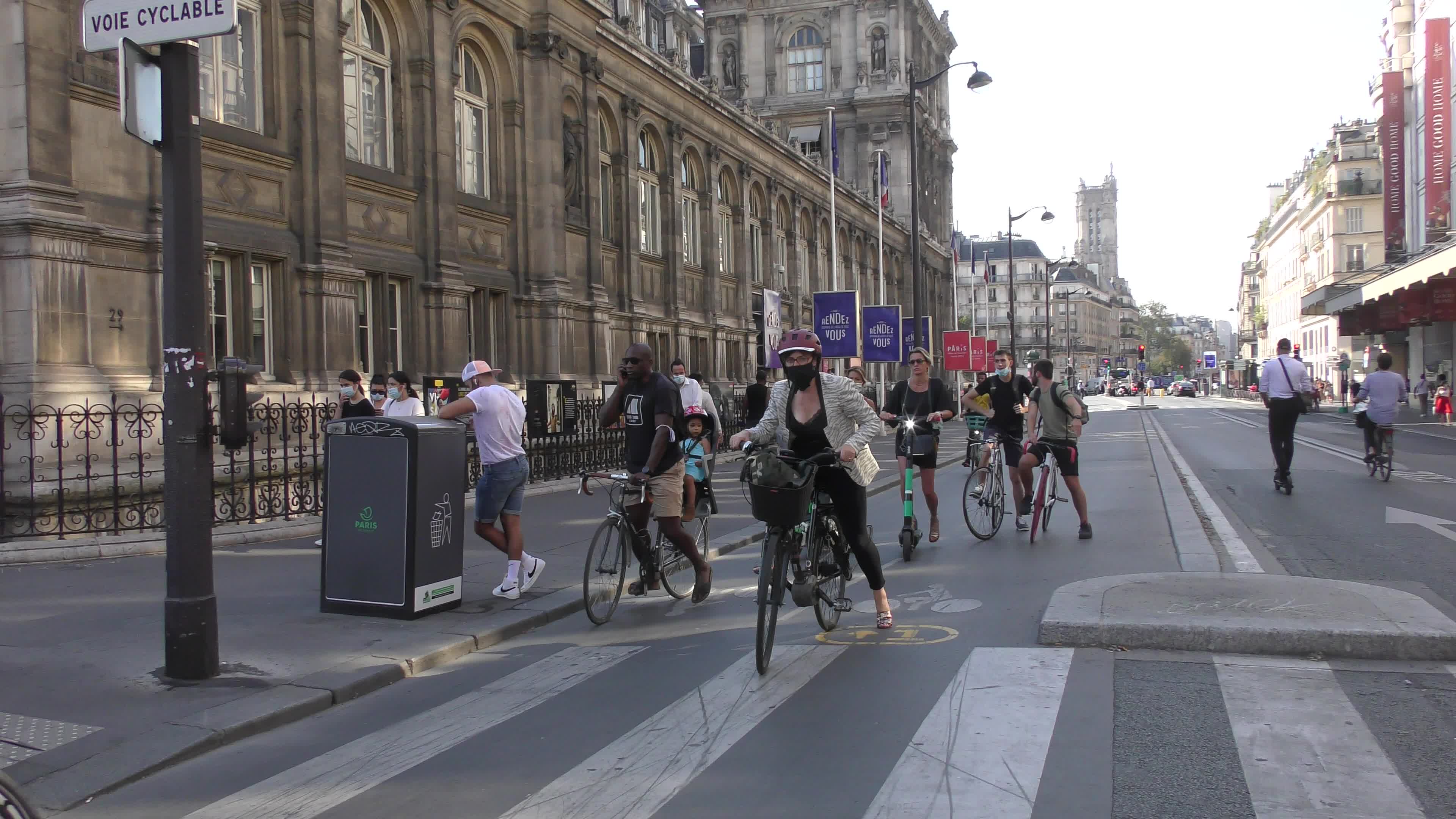 Parisians and commuters cyclists rides in Paris on Rue de Rivoli 