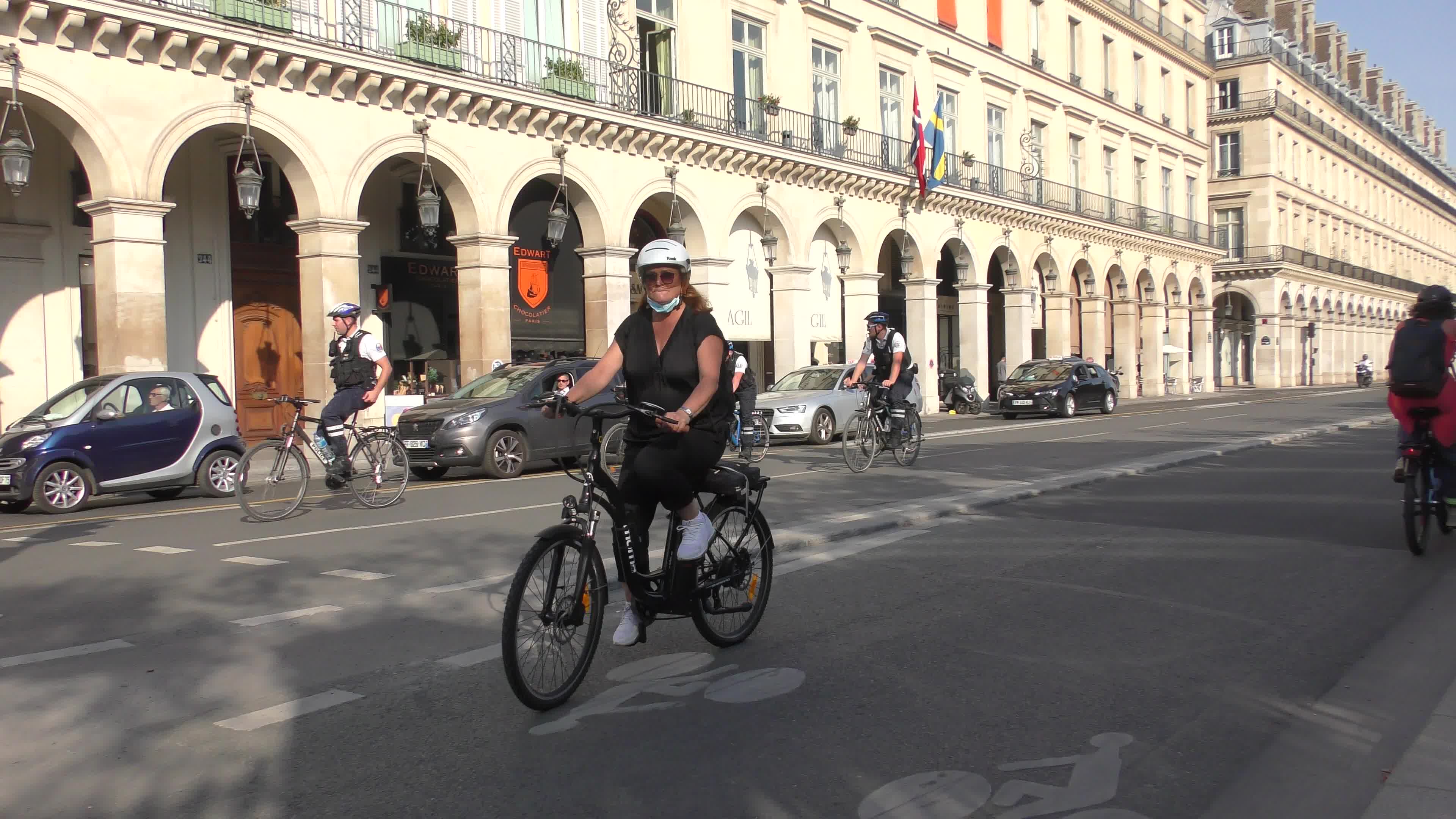 Parisians and commuters cyclists rides in Paris on Rue de Rivoli 