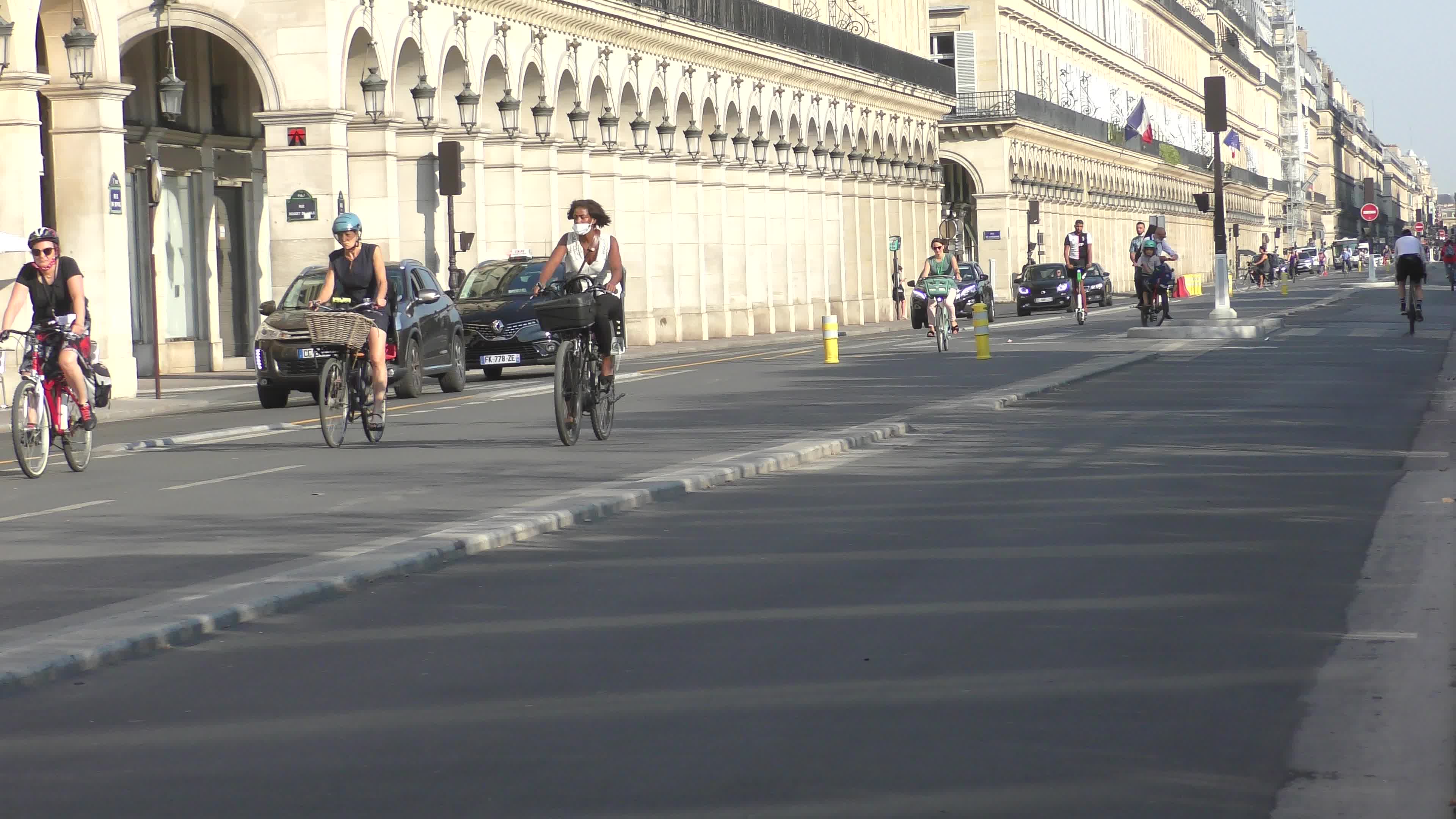 Parisians and commuters cyclists rides in Paris on Rue de Rivoli 
