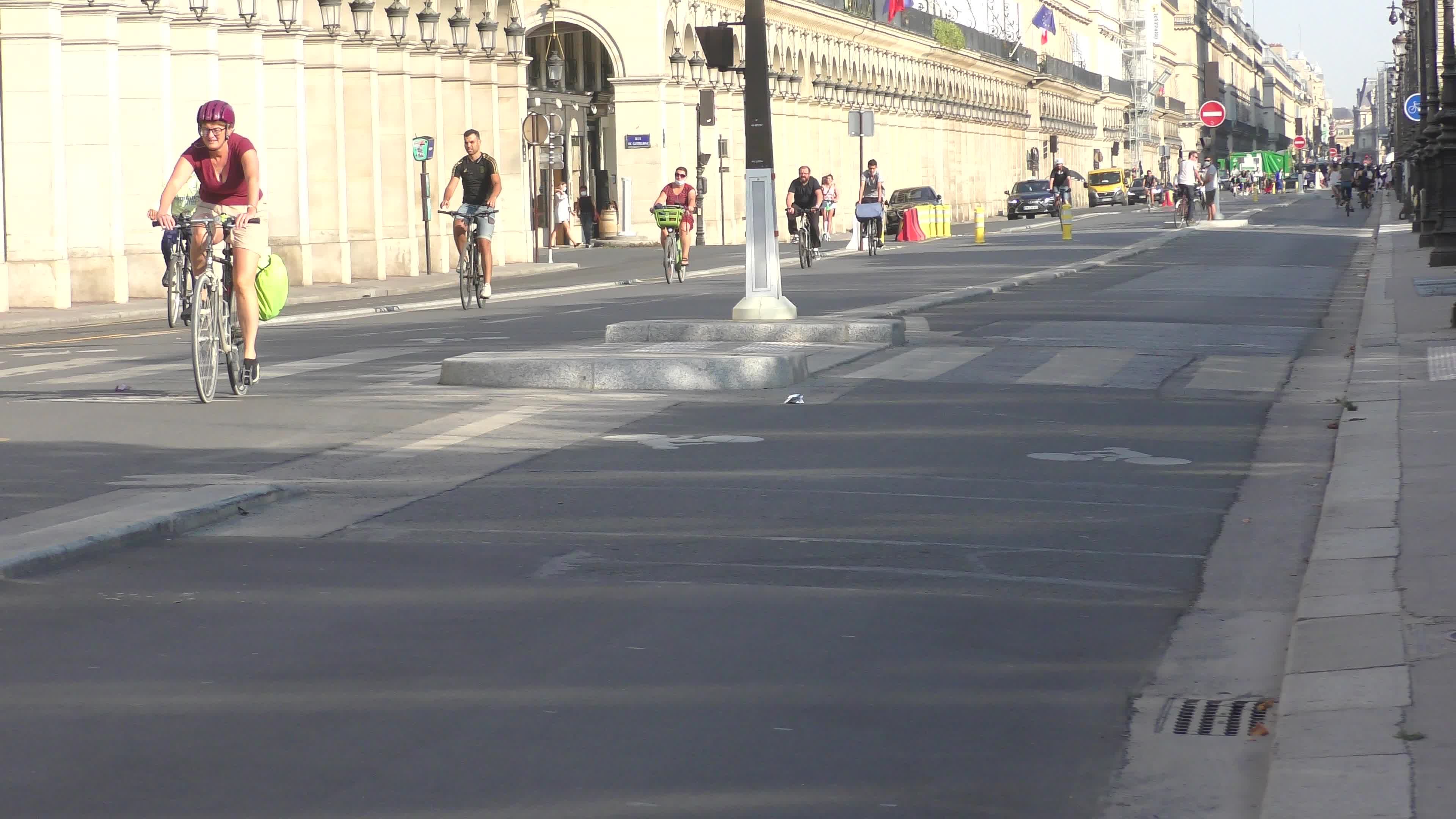 Parisians and commuters cyclists rides in Paris on Rue de Rivoli 