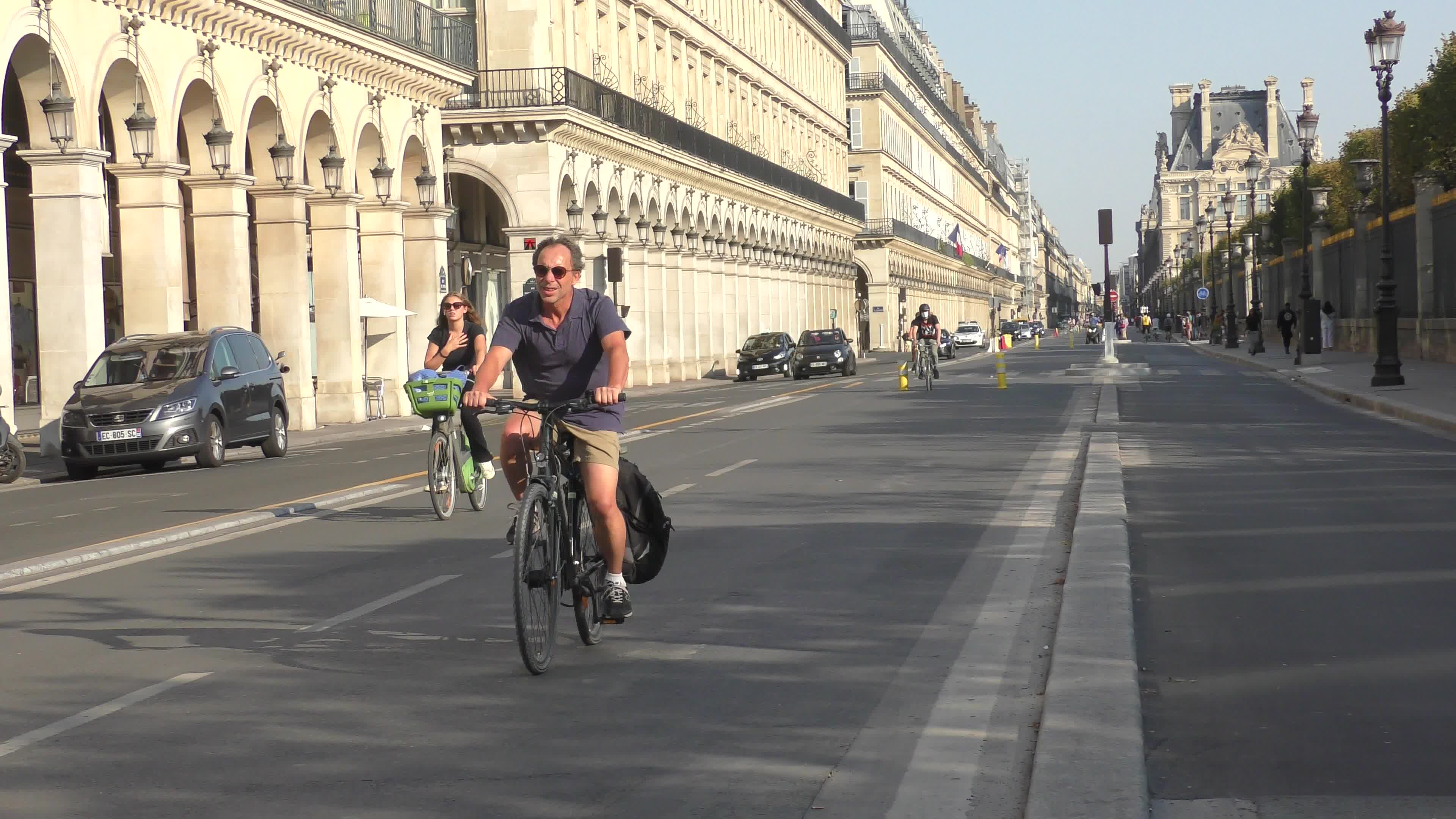Parisians and commuters cyclists rides in Paris on Rue de Rivoli 