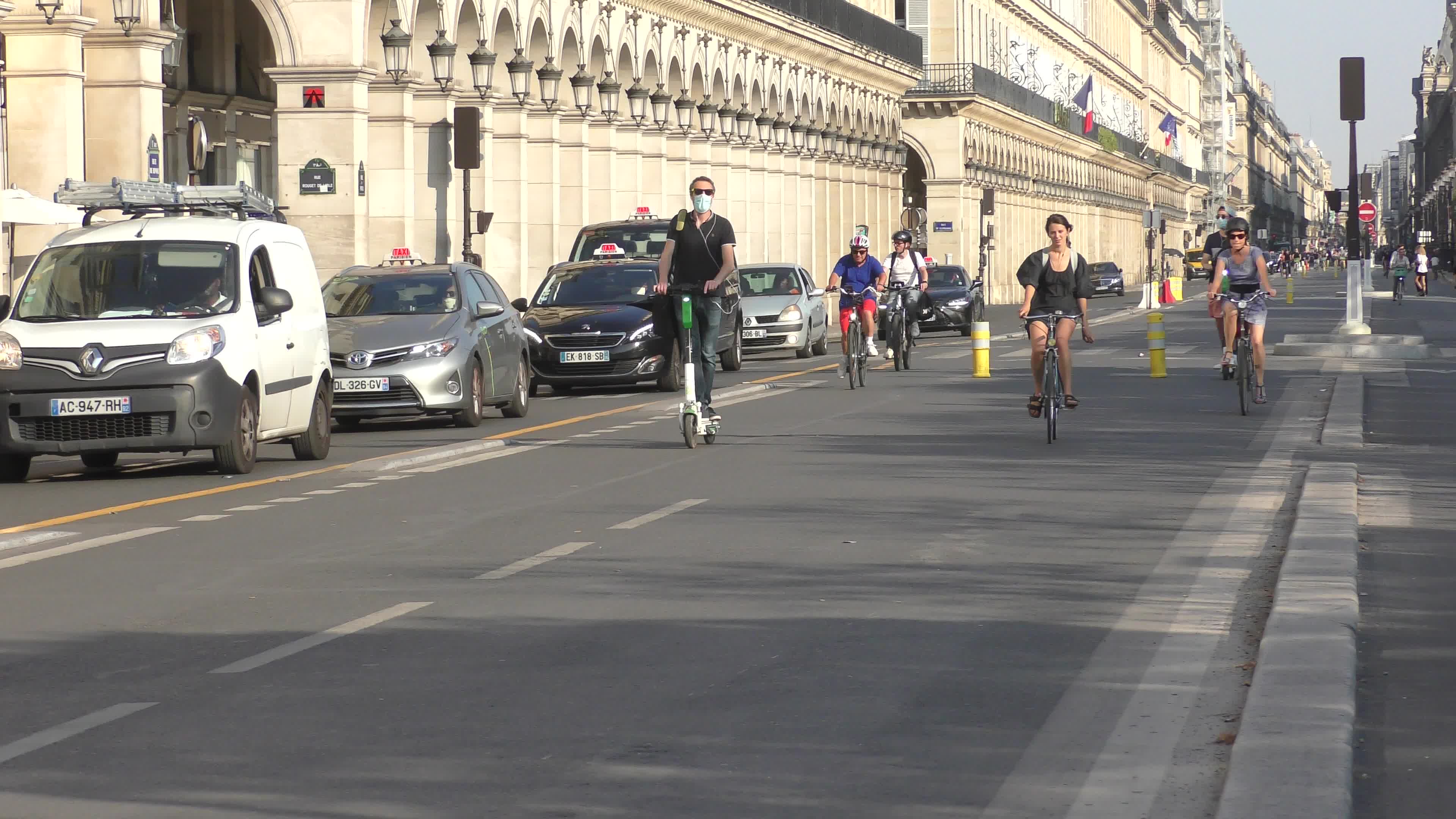 Parisians and commuters cyclists rides in Paris on Rue de Rivoli 