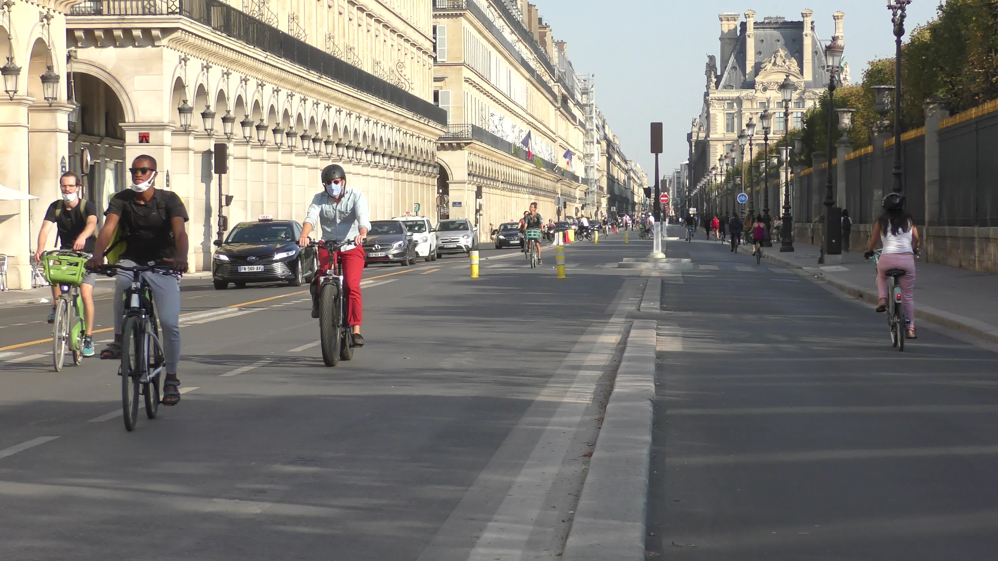 Parisians and commuters cyclists rides in Paris on Rue de Rivoli 