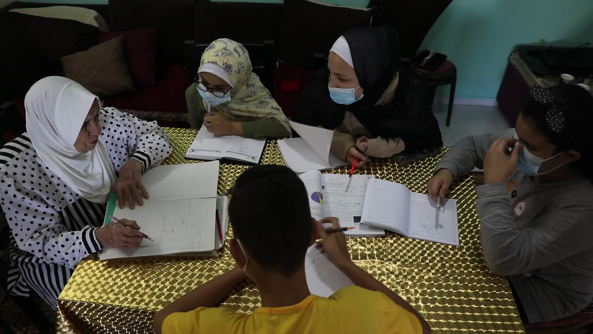 80-year teacher teach to students amid the COVID-19 pandemic in Gaza