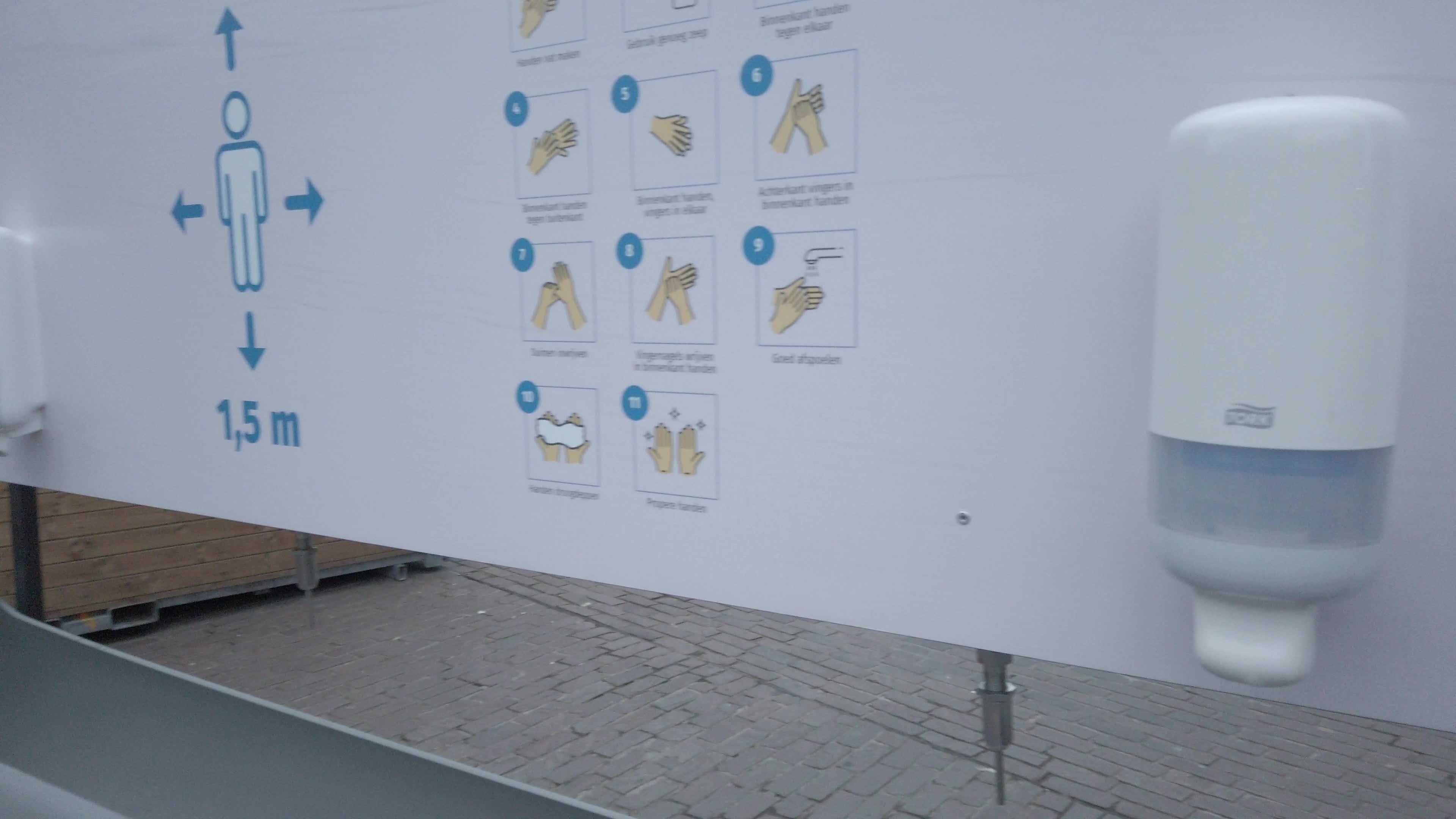 Installation of a public hand sanitizer in Korenmarkt