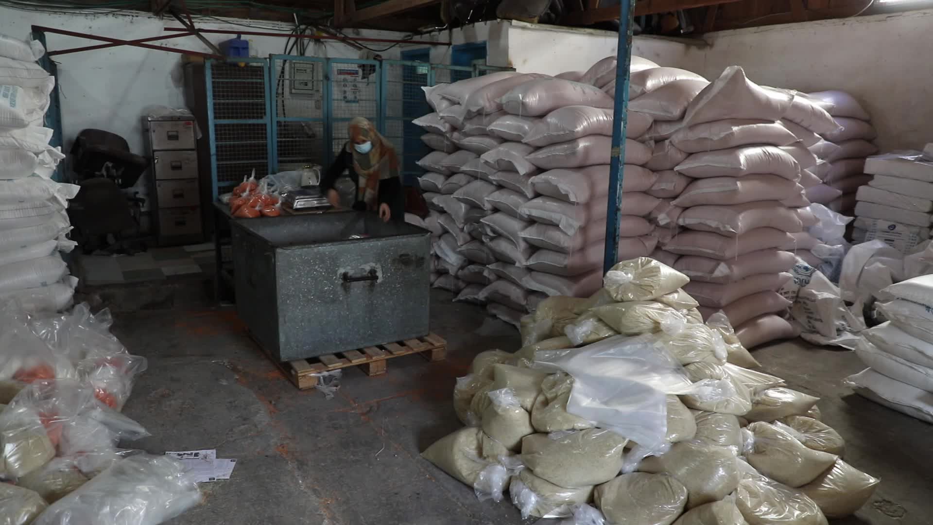 Palestinian refugees receive aid distributed by UNRWA in Gaza