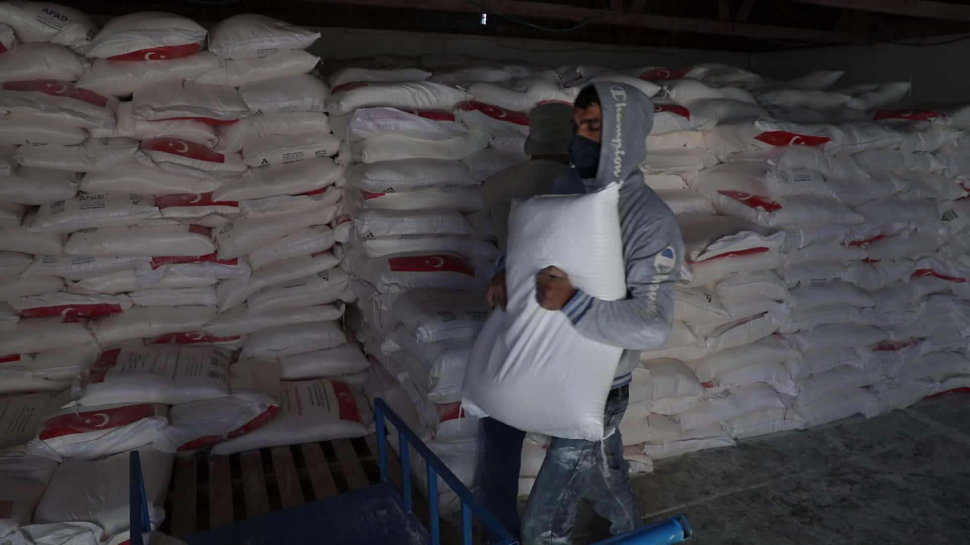 Palestinian refugees receive aid distributed by UNRWA in Gaza