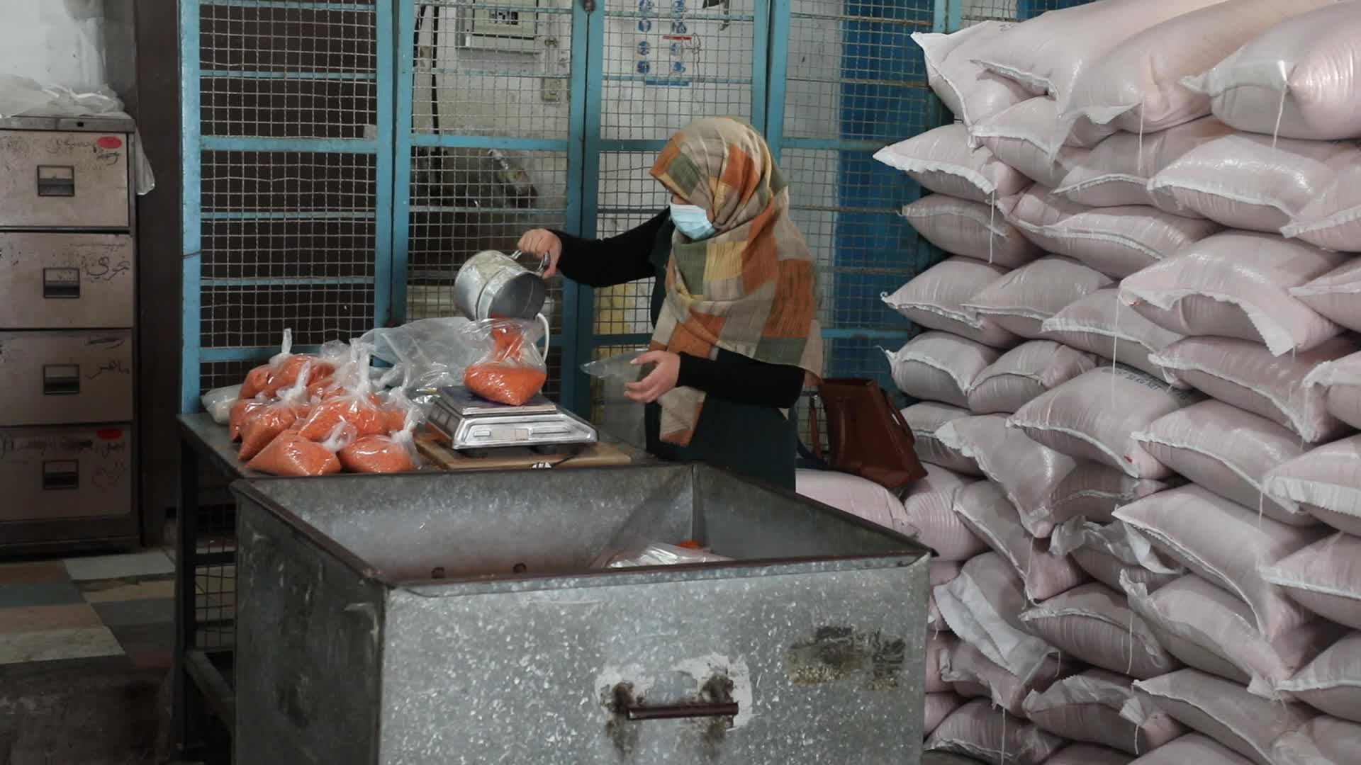 Palestinian refugees receive aid distributed by UNRWA in Gaza