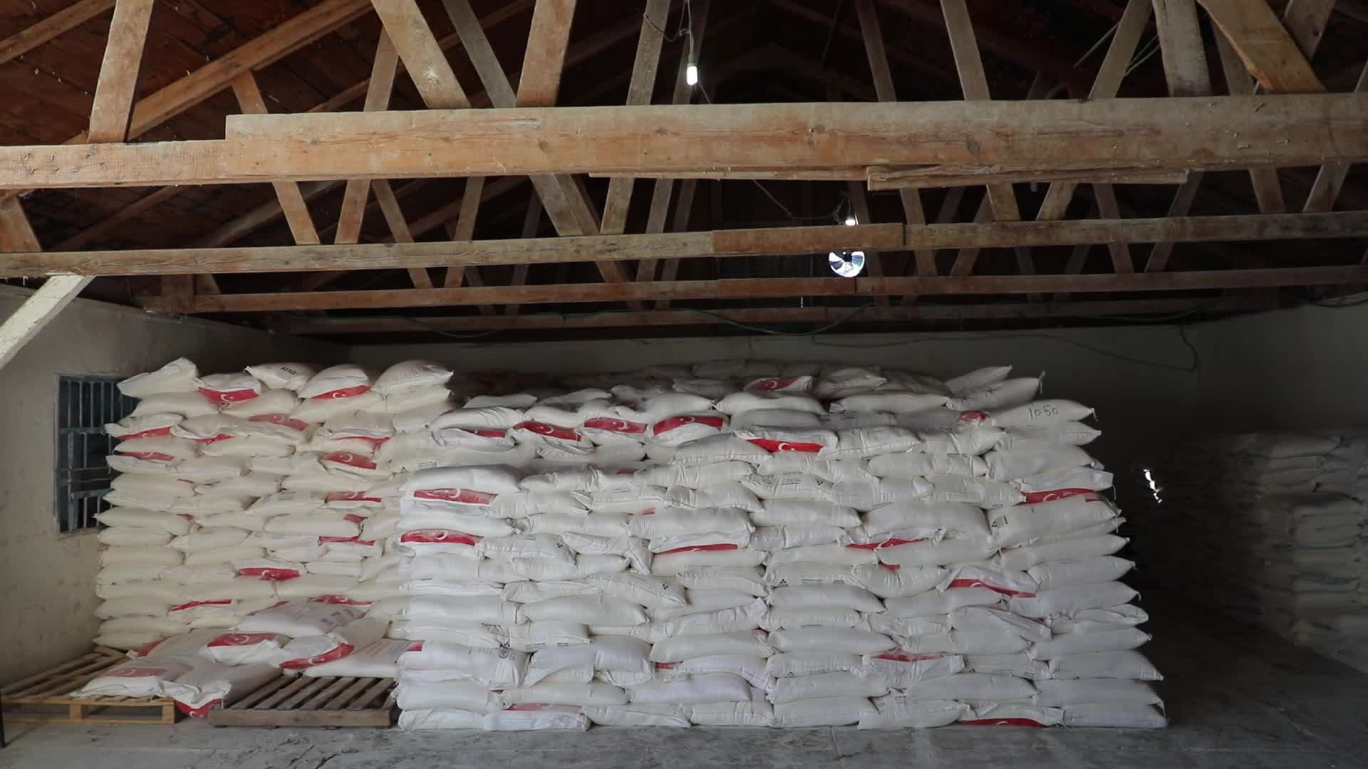 Palestinian refugees receive aid distributed by UNRWA in Gaza