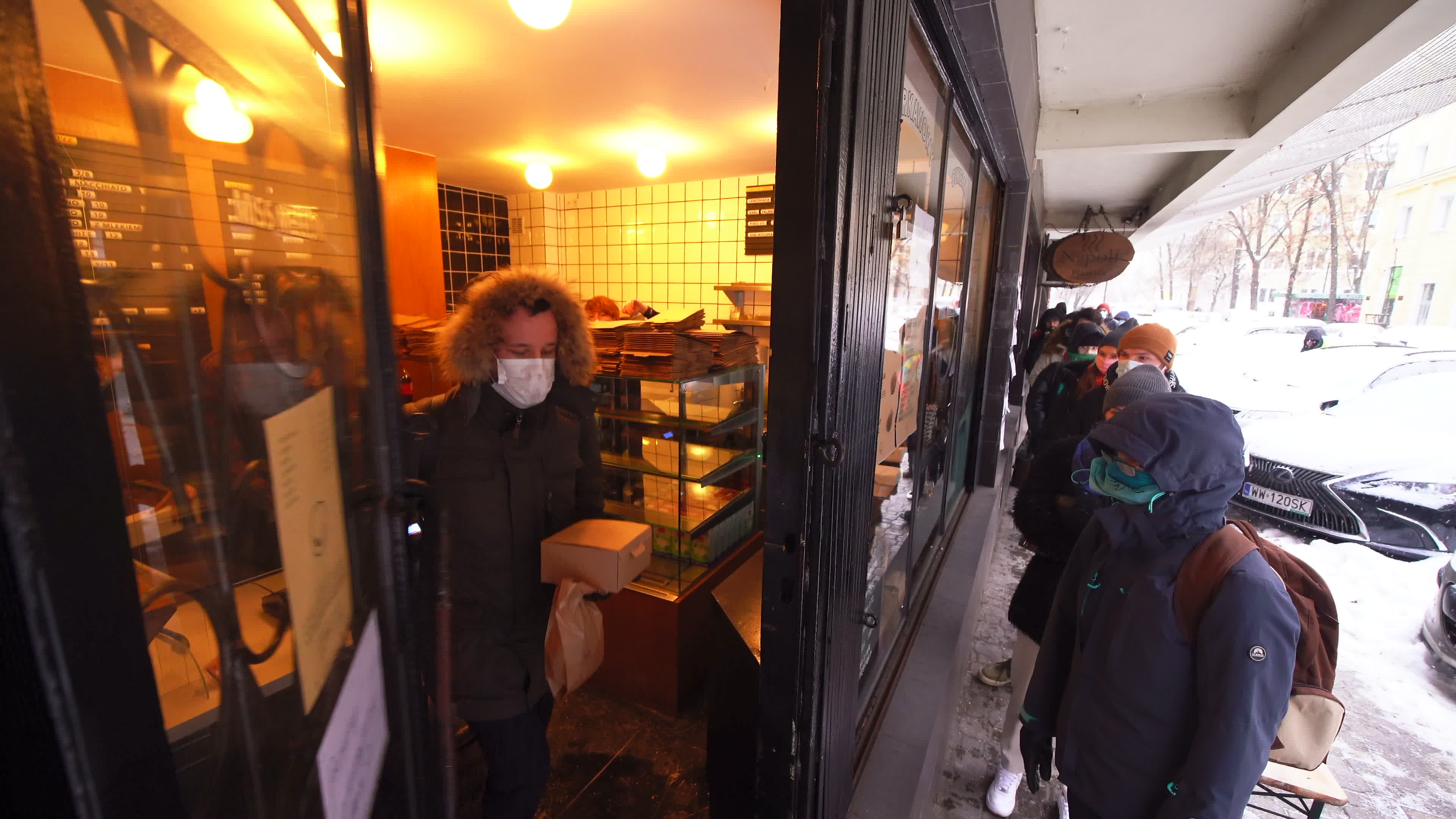Poles queue in the cold for donuts