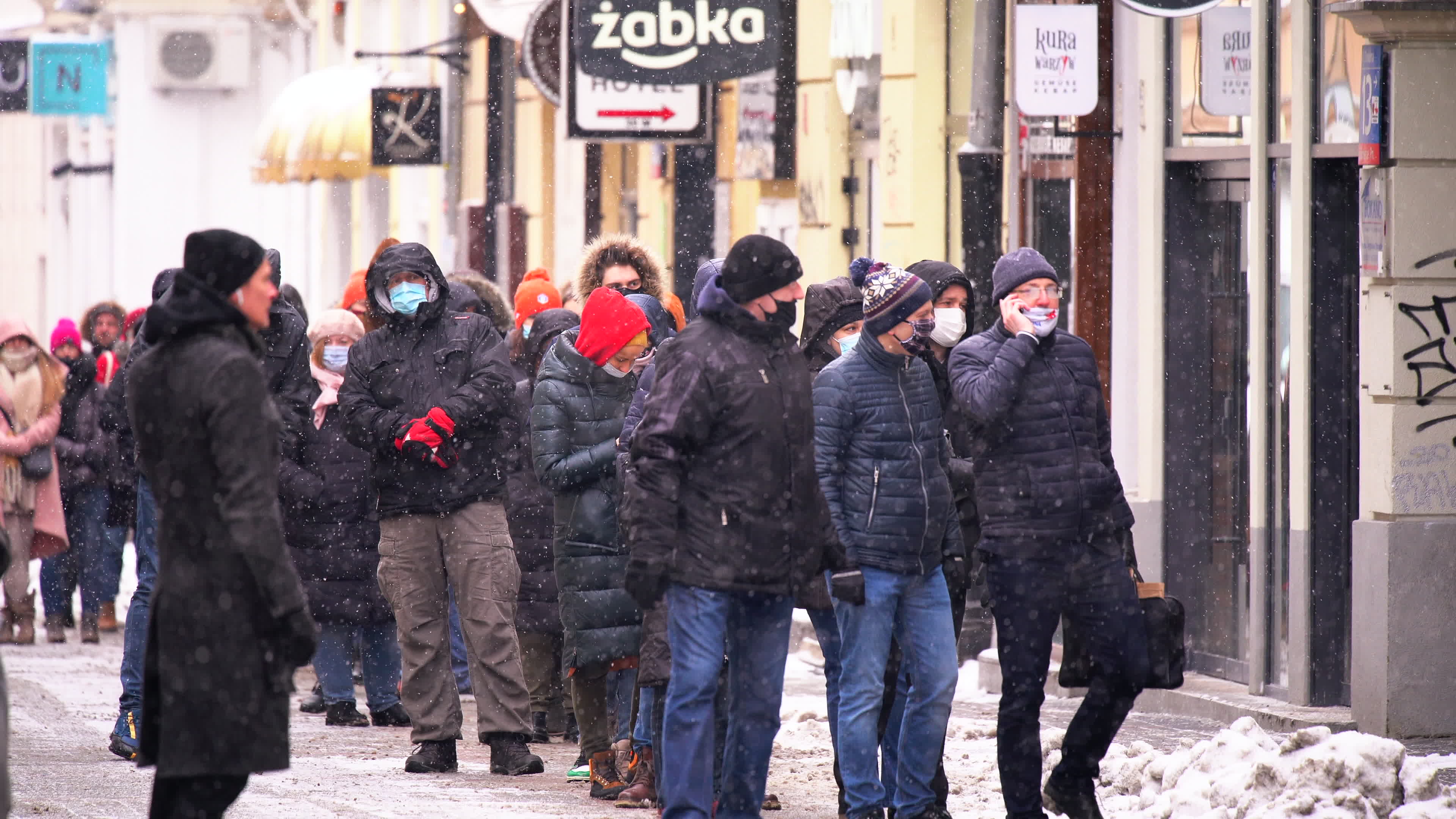 Poles queue in the cold for donuts