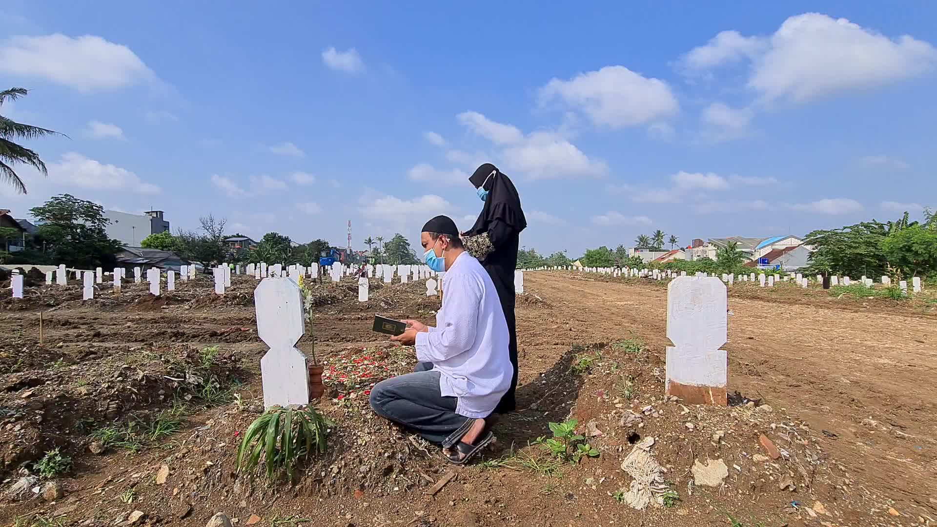 People visits a Covid-19 graveyard in Indonesia